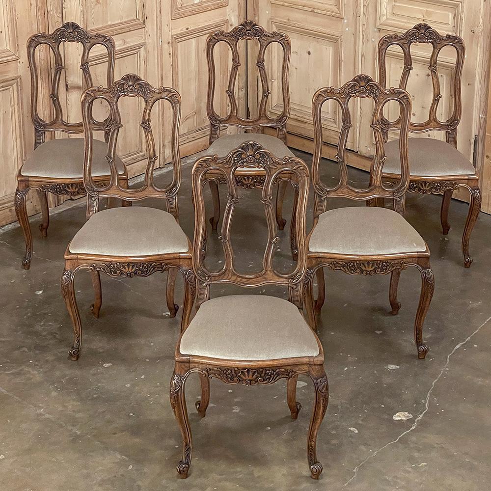 Set of 6 French Louis XV dining chairs with Mohair are the perfect blend of style, comfort, and quality craftsmanship! The frames are sculpted from solid old-growth oak, and feature a triple arched seatback crown carved with shell, floral and