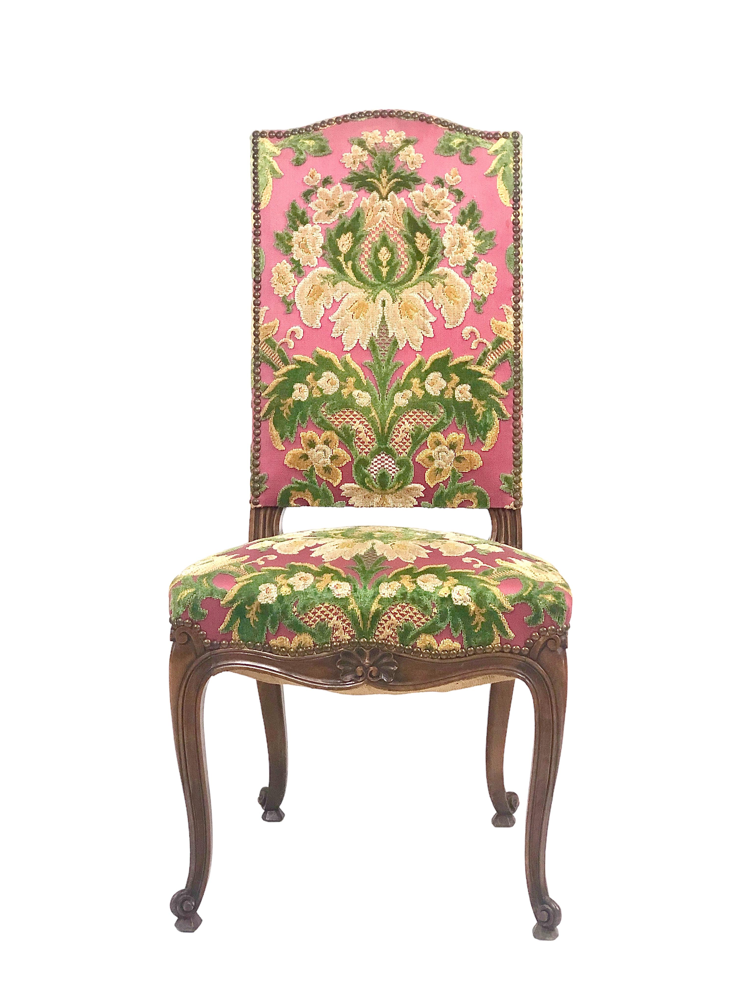 An elegant set of six antique oak and cut velvet French Louis XV style dining chairs, with very comfortable, sprung seats and cabriole legs. Each chair is exquisitely upholstered in a decorative floral design of cherry-pink and green velvet. 
 The