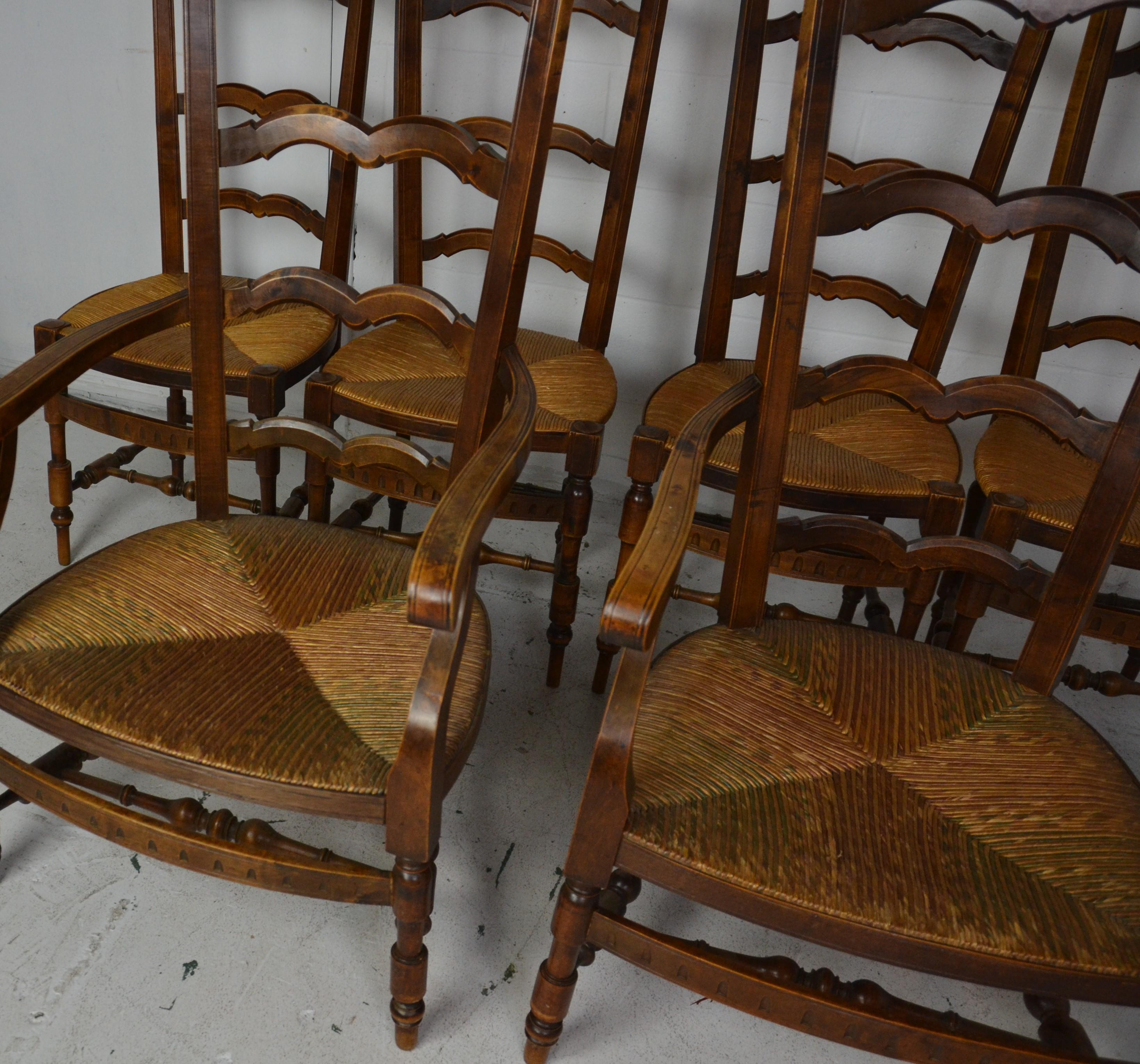 A set of 6 (2 arms + 4 sides) French Provincial ladder-back chairs with ultra-high backs. Walnut finish topped, turned finials to the top. Finely turned legs and double stretchers. Rush seats. Measures: Armchair 23