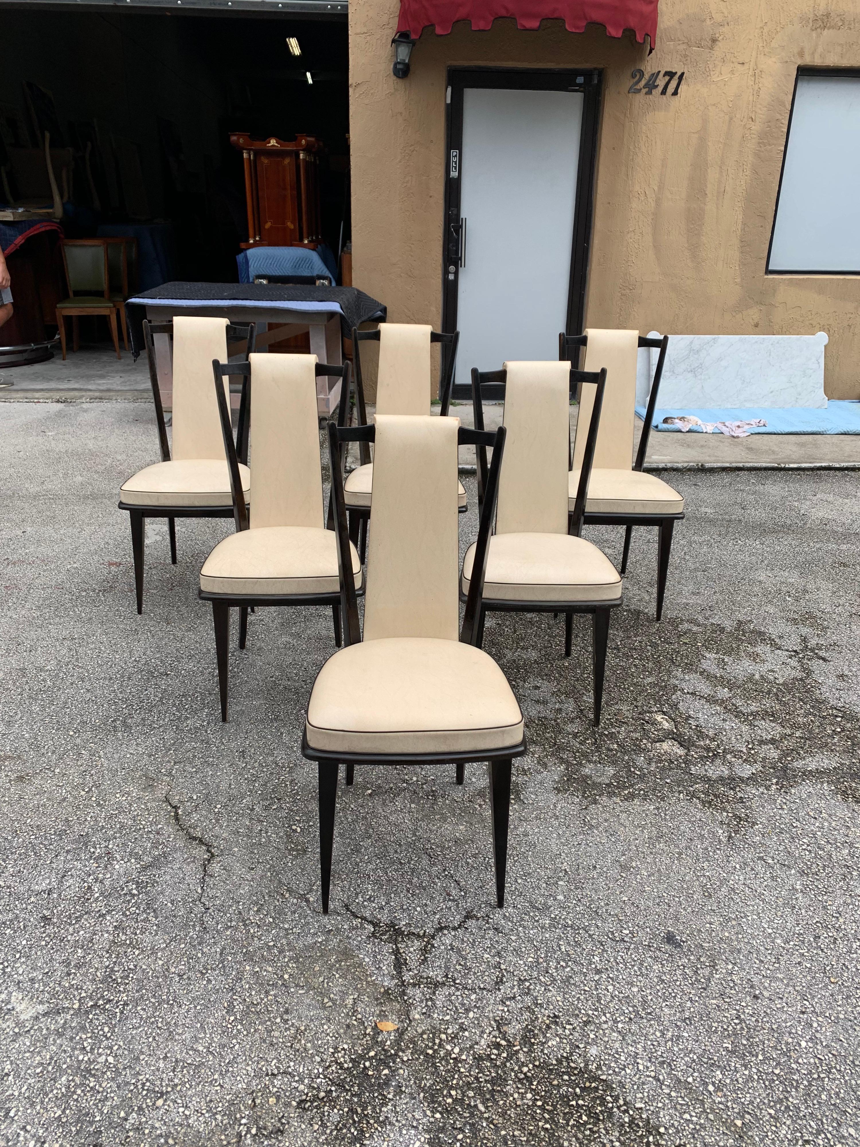 Classic set of six French vintage dining chairs Macassar ebony, circa 1940s, the two front feet are capped with brass. The chair frames are in excellent condition. (The Reupholstery is vinyl recommended to be change for all 6 dining chairs) ,the