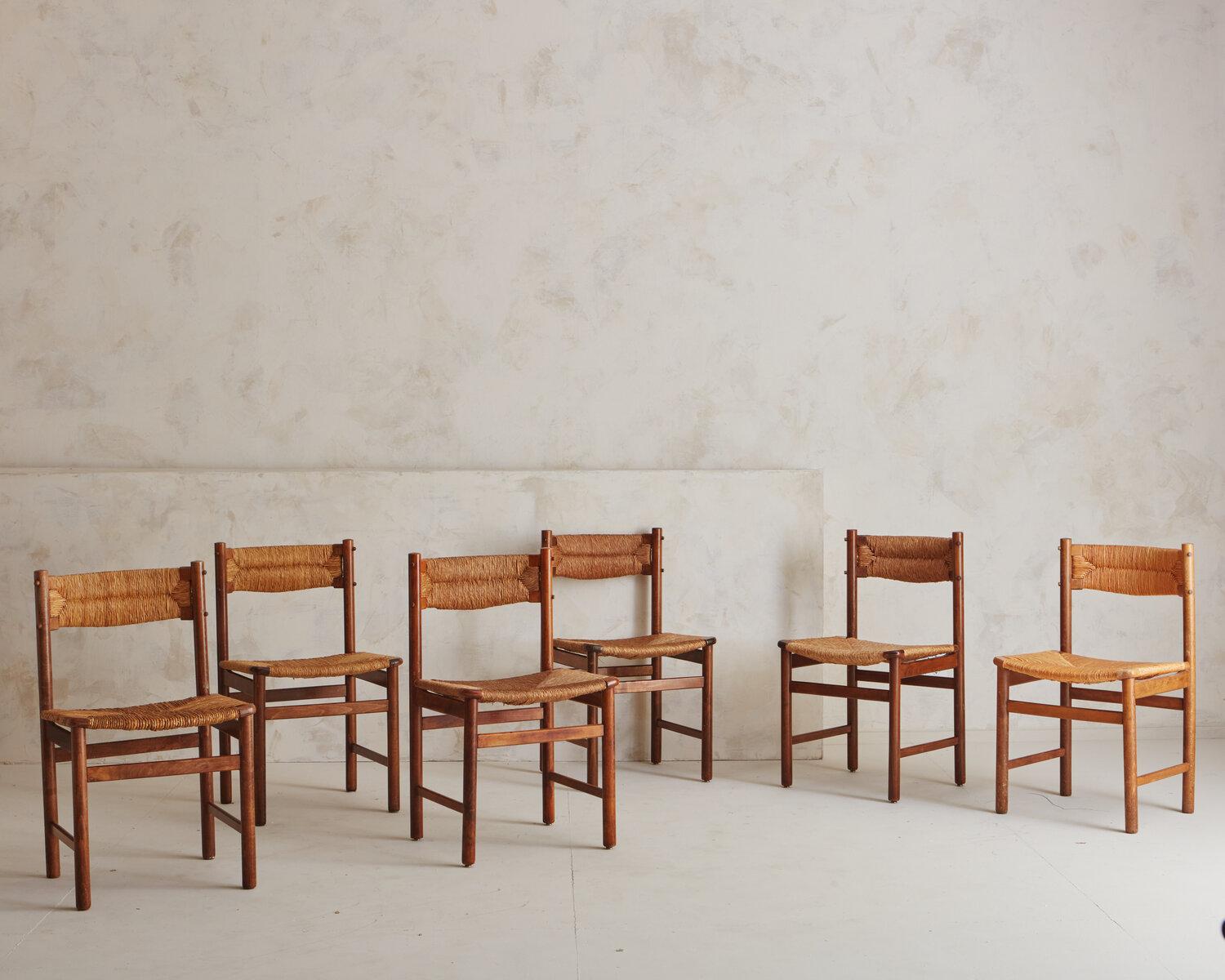 A set of 6 French Dining Chairs in wood and rush. Sourced in France, 1950s. These Classic chairs showcase a harmony in design, material and construction. 

DIMENSIONS: 29.75”H, 31”H, 31.25”H x 18.25”W x 15.5”D; 17.25”Seat Height.
