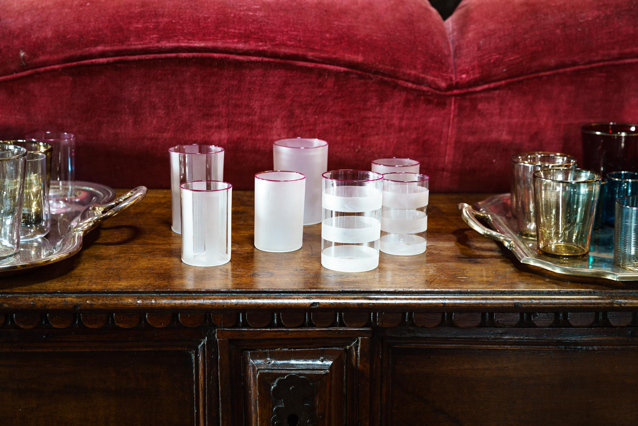 The Stricca glass is a cylindrical, transparent vessel animated by opaque vertical or horizontal stripes and completed with a vivid red rim. Seen as an evolution of Frost, it retains the same pure, regular lines of a clear cylindrical form, yet