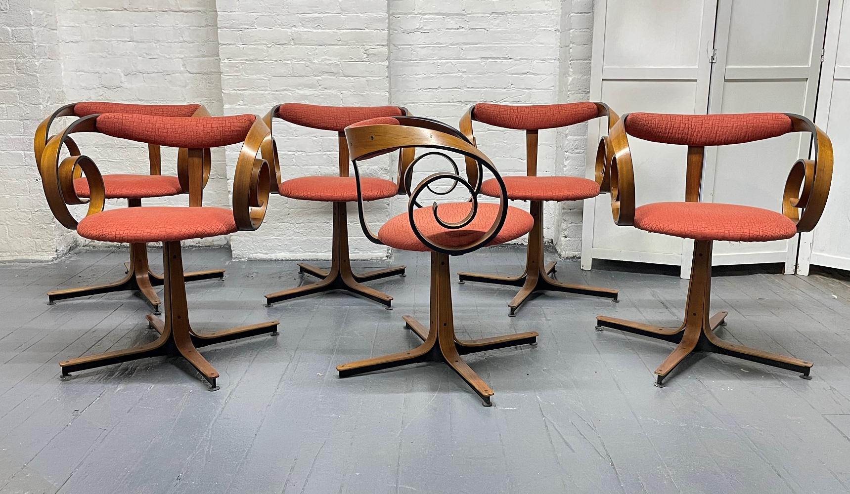 Set of 6 George Mulhauser swivel chairs for Plycraft. Walnut frames with fabric covered seats. Scrolled arms.