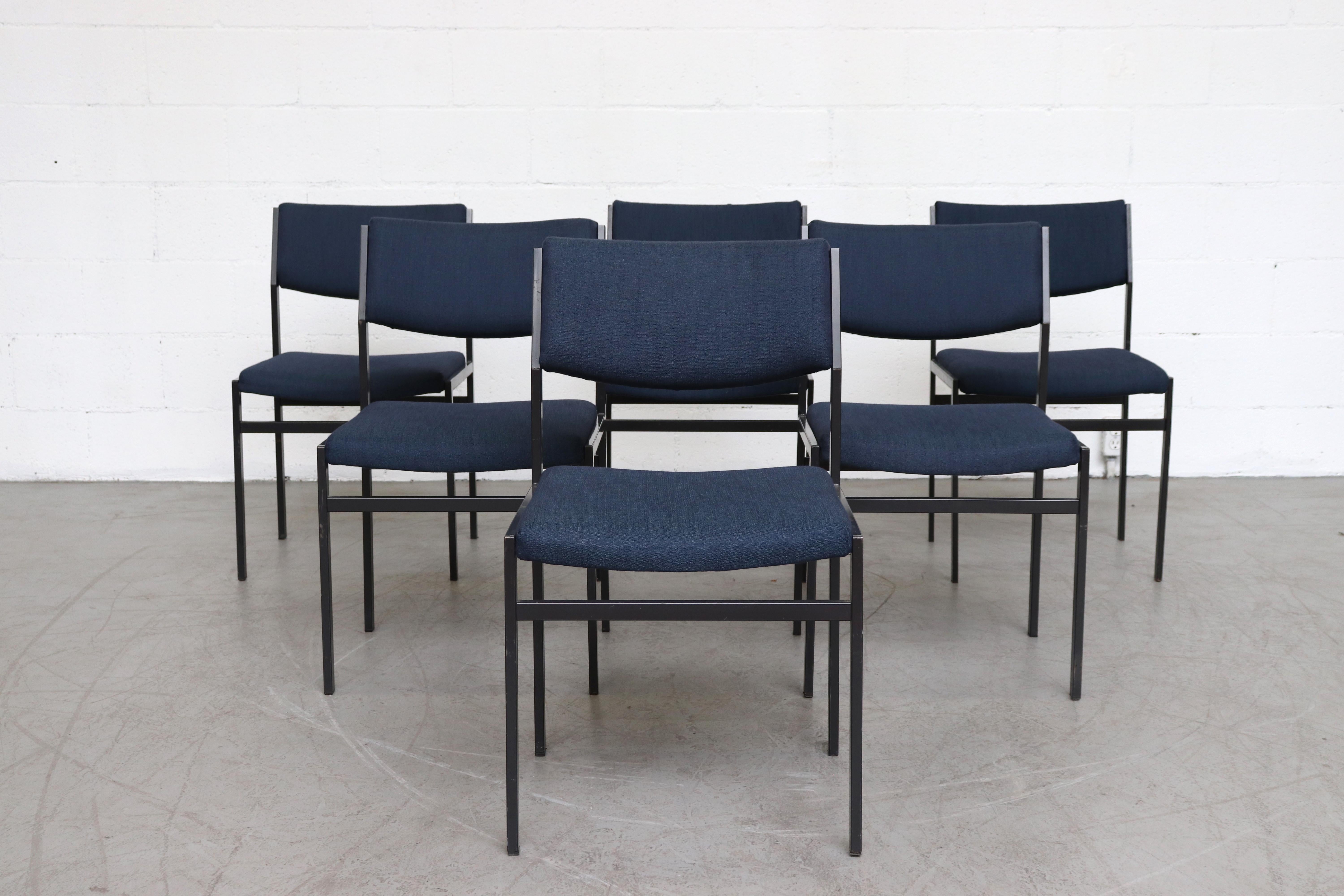 Newly upholstered set of 6 dining chairs in indigo fabric with original enameled metal frames, slight crescent moon shaped backs. Frames in original condition with visible wear and some paint loss and scratching. Set price.