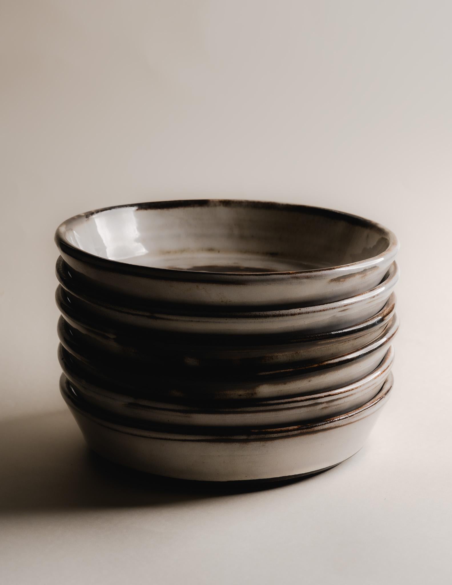 Set of 6 Glazed Stoneware Plates, Signed Gérard Hoffman, 1970s.
Each piece features nuanced white and brown glazing, highlighting the depth and texture of hand-thrown stoneware. French work from the 1970s. Excellent condition, with natural
