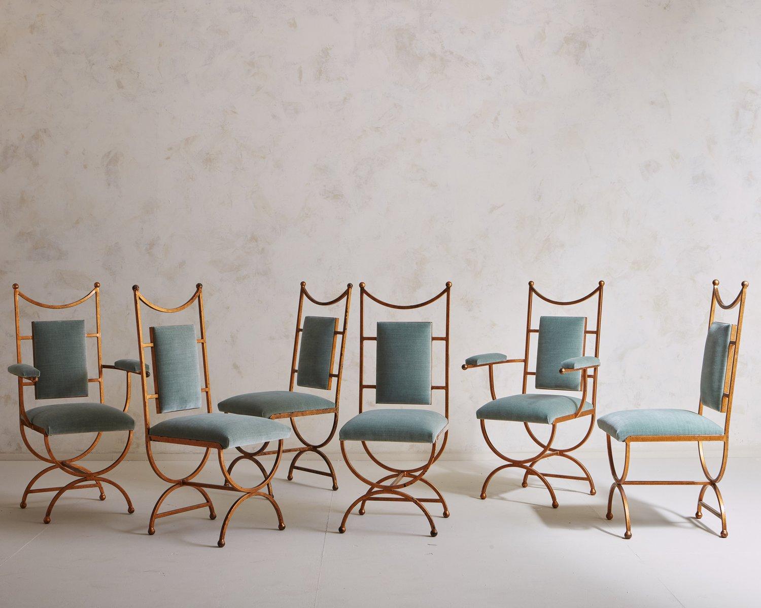 A handsome set of six vintage dining chairs featuring intricate metal frames with a painted brushed gold finish. The frames have high backs with curved lines and petite ball details. These beauties were newly upholstered in a seafoam green velvet