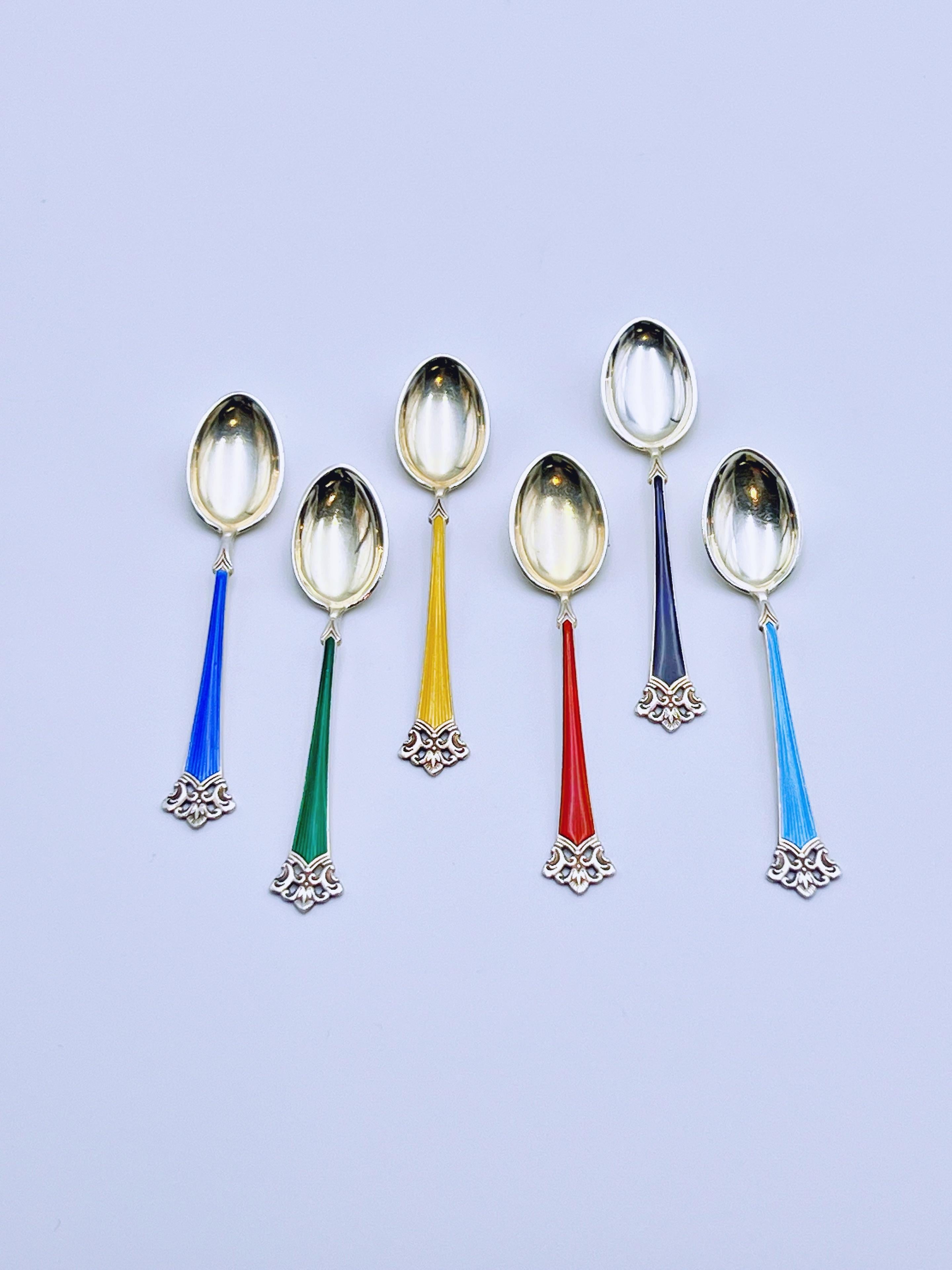 A set of 6 Luxury sterling silver and enamel spoons / teaspoons with gold gilt / gold-plated decoration. Features six distinct colors of enamel. Designed and produced in Norway by Magnus Aase, circa 1960s.

Exquisite Norwegian / Scandinavian /