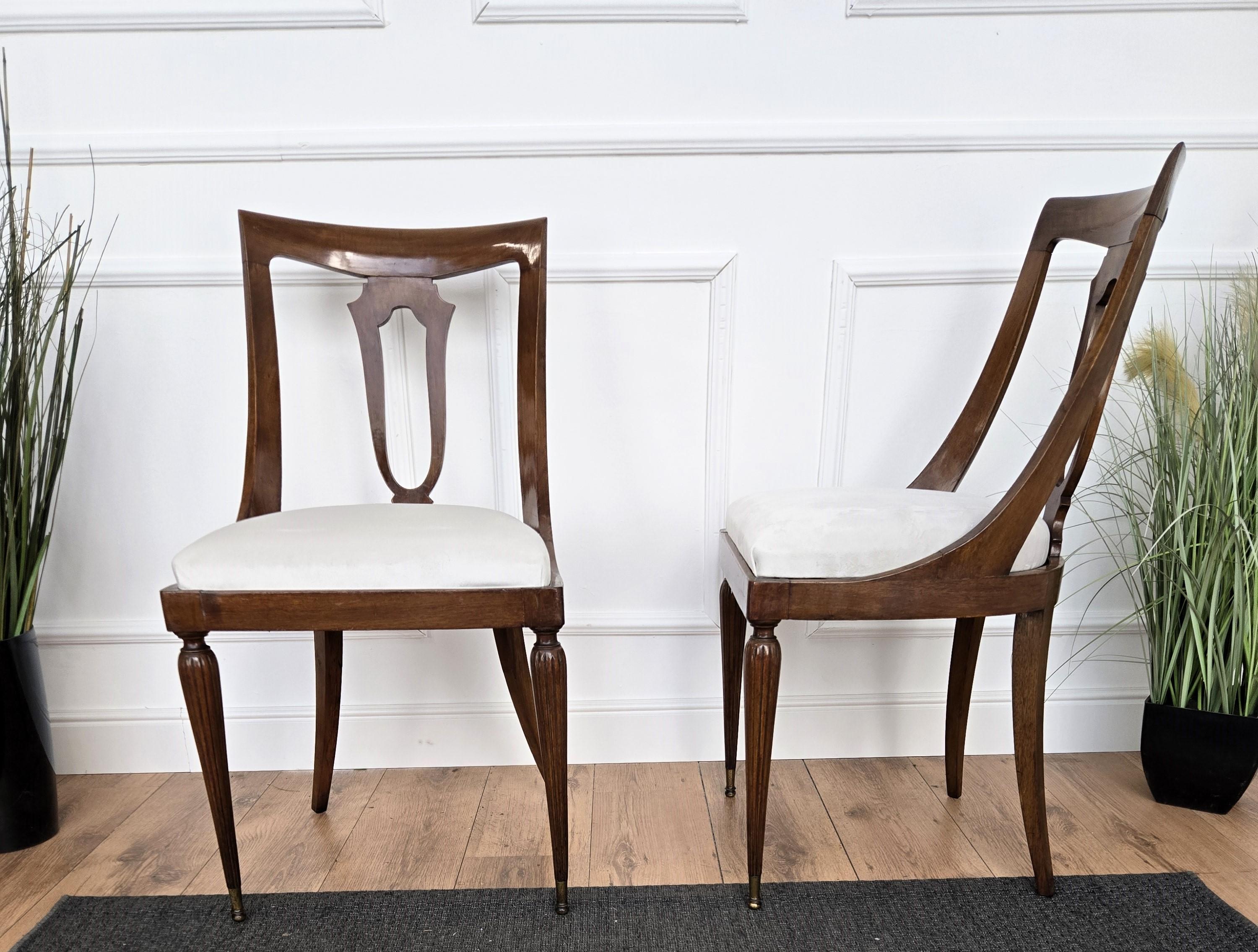 Beautiful and stylish Italian set of six dining chairs in the style of the classic gondola design with greatly worked and shaped wooden structure and fabric upholstered seat. The unique and typical design, with the clean geometric shape and