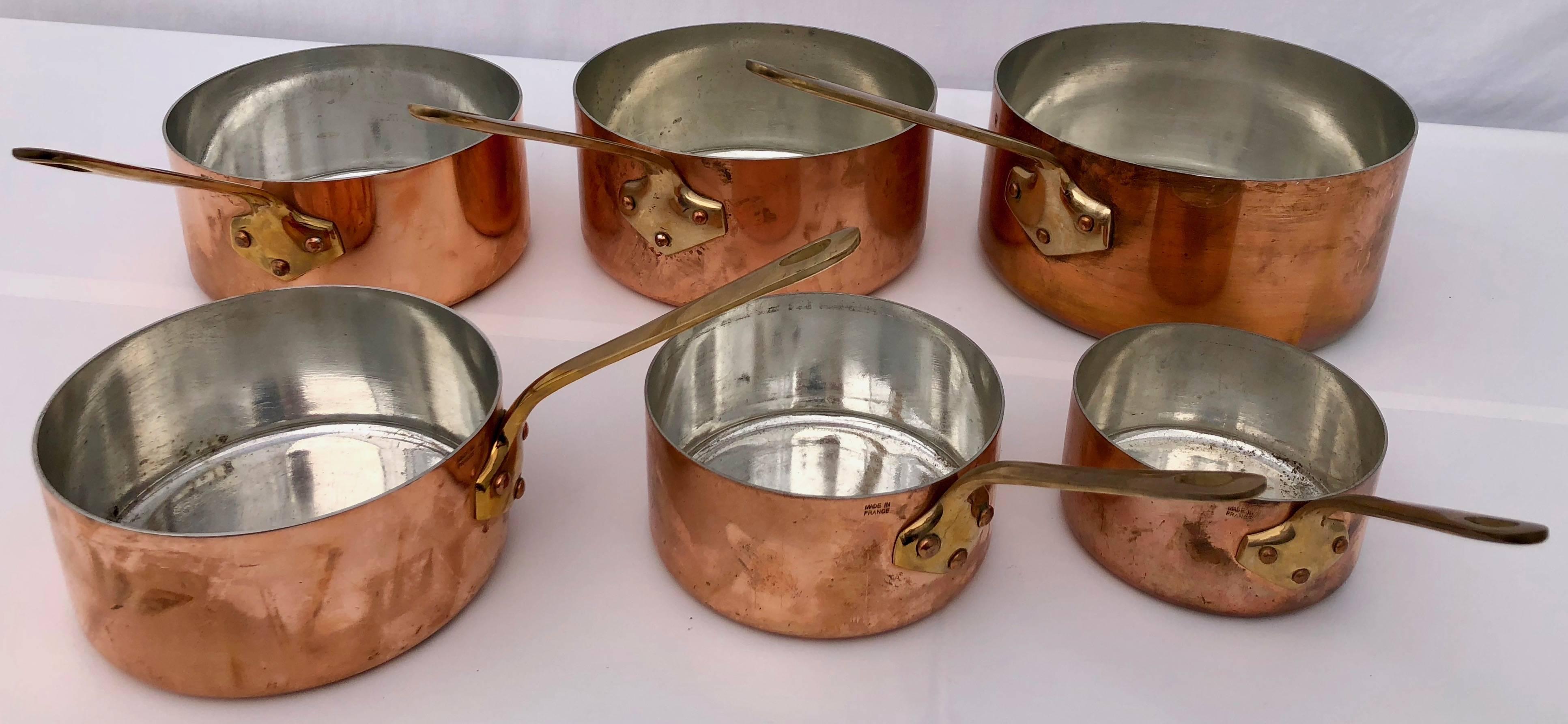 This is a great set of French copper pans. They are in graduating sizes and all have brass handles. They are a semi-professional grade with a tin plated inside. They have never been used except for maybe for the large pan. They were made in