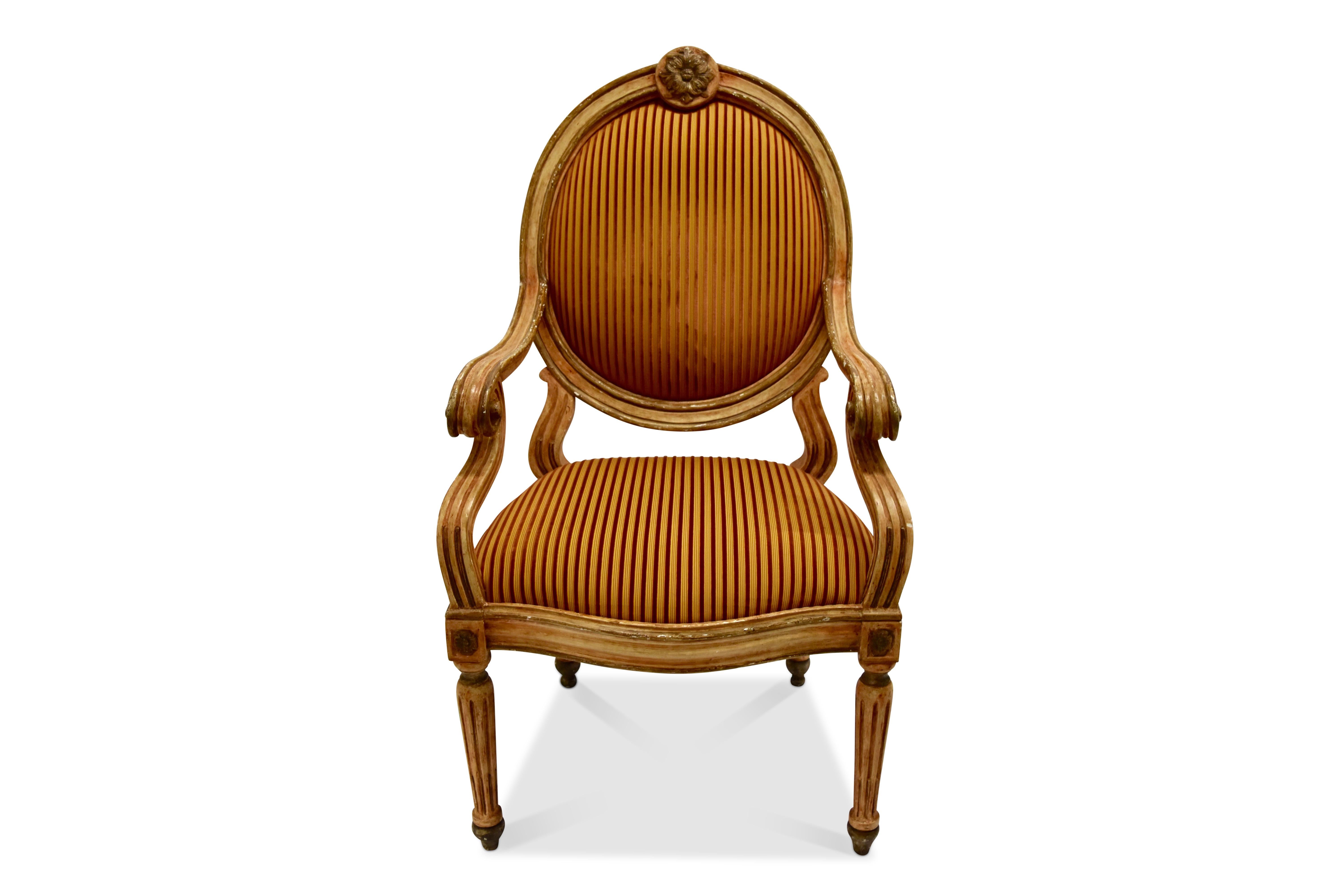 Each with a painted and gilded frame, having an oval upholstered inset back, fluted arms resting on a similarly fluted rail seat with an upholstered inset, all on turned fluted legs.