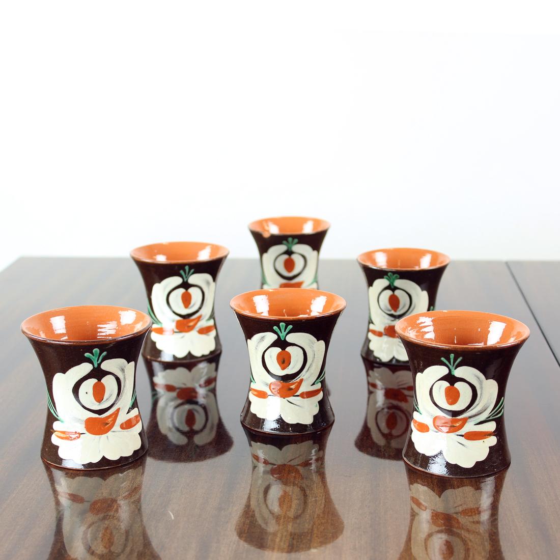 Unique and rare set of vintage cups. Produced in Pozdisovce region in Czechoslovakia which is famous for the style. It always has a black/dark background where floral ornaments in vivid colors are painted on. The cups are a set produced in 1950s,