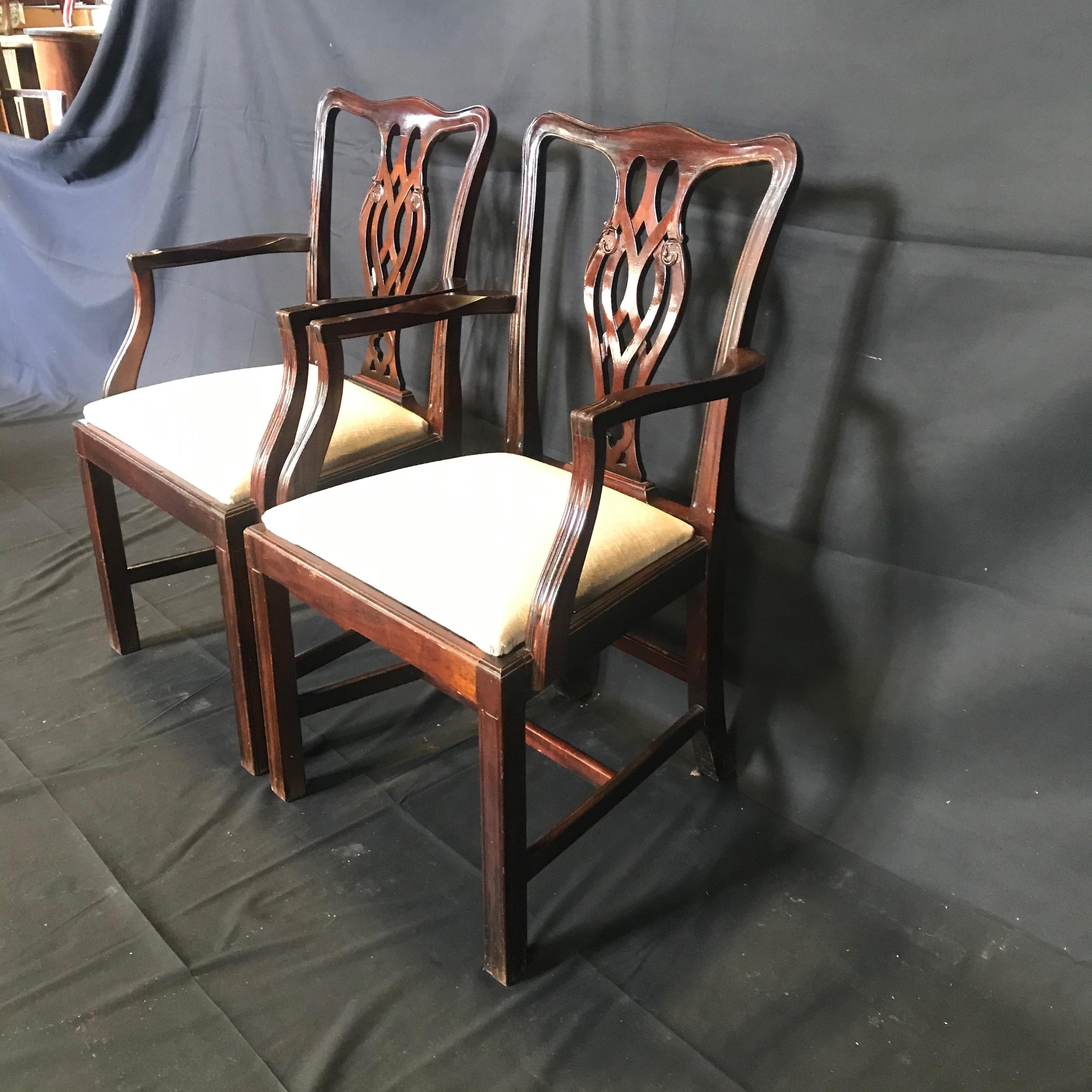 A set of six very handsome fine English Chippendale style dining chairs with two armchairs and four side chairs. Each chair is beautiful mahogany with exceptional color and rich patina. There is some color variation due to light exposure over the
