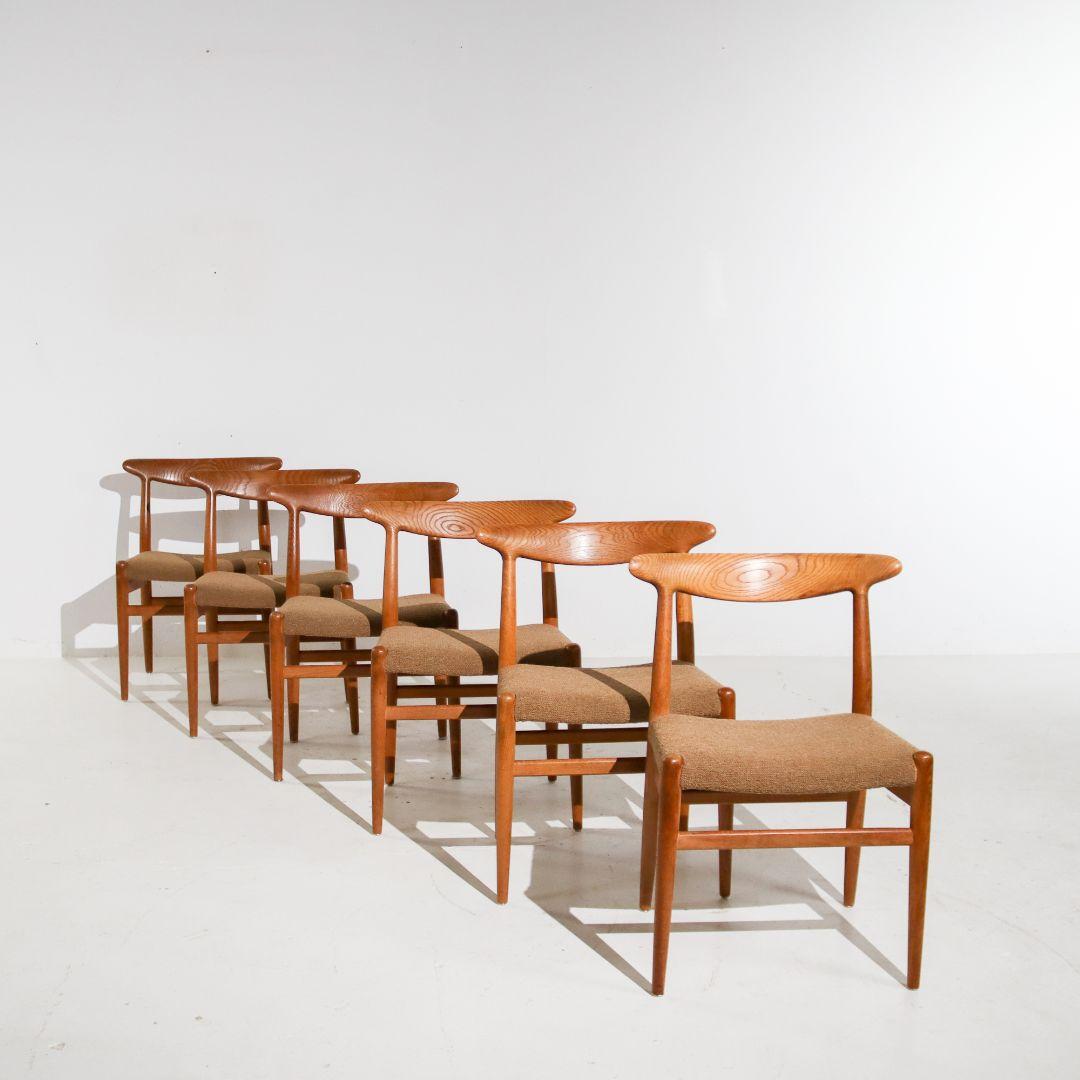 A set of six rare 'W2' chairs by Hans Wegner for C.M Madsens Denmark. Hans Wegner, also known as 'the master of the chair', designed the model in 1953. Production took place in the 1950s. The frame is made of solid oak and the fabric is made of a