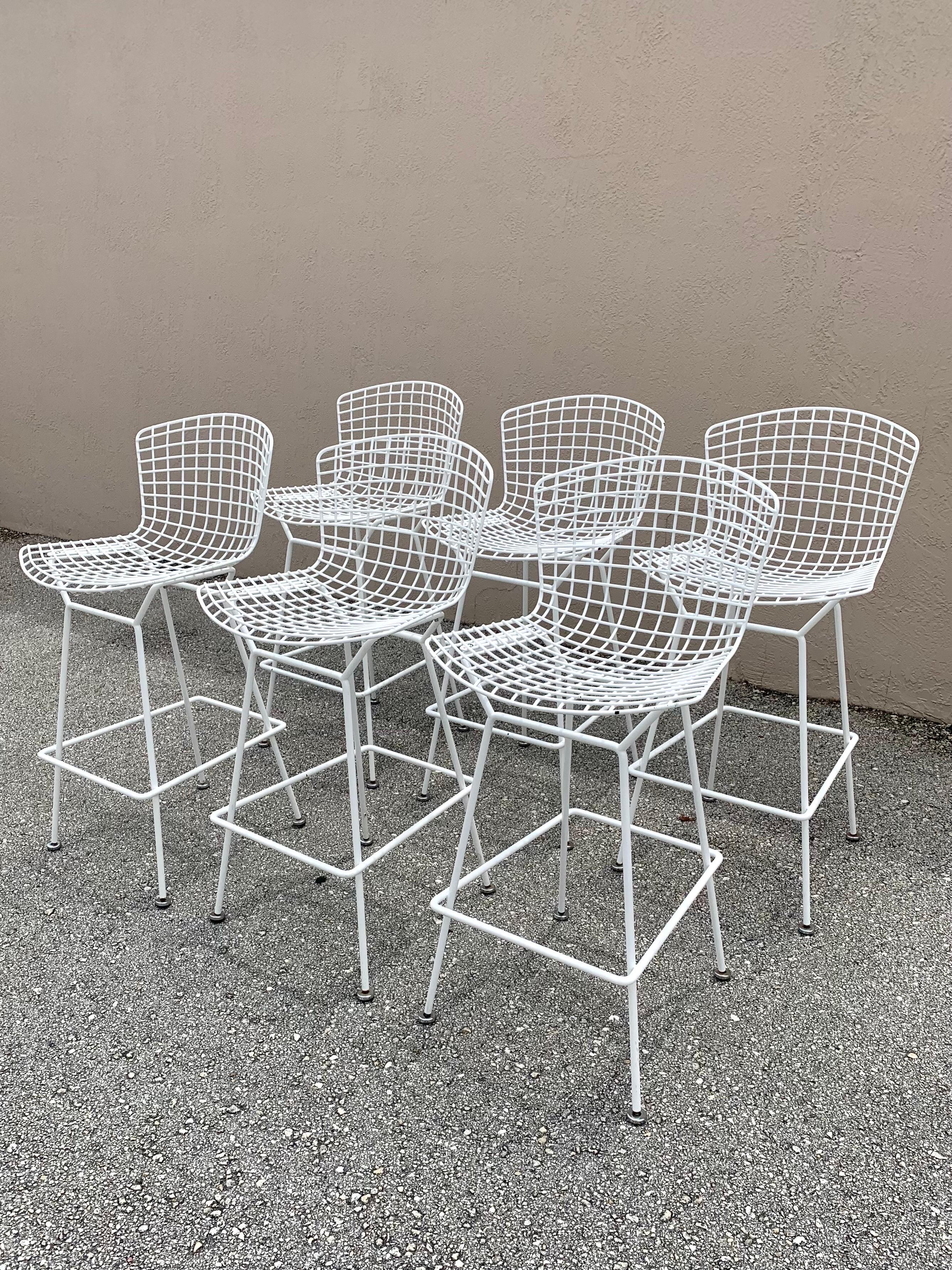 Set of 6 bar stools by Harry Bertoia for Knoll. A beautiful and classic design by one of the most notable Mid Century designer and artist. Each one retains its original white powder coating. 

There is some wear to each one. Some light some more