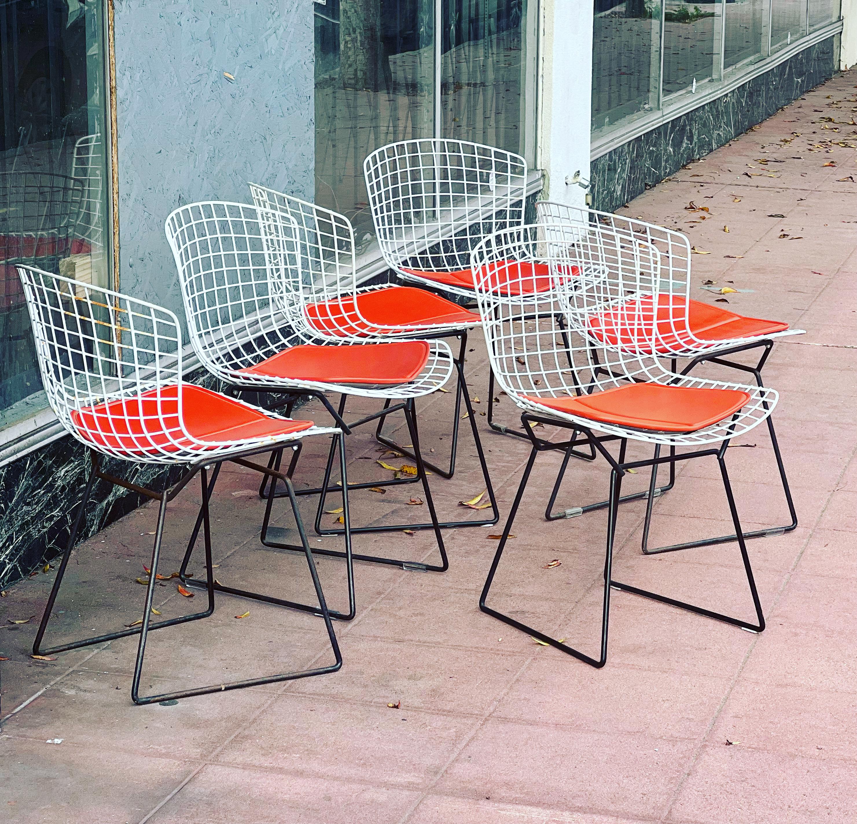 Great set of 6 side chairs designed by Harry Bertoia for Knoll, circa the 1980s in original condition with orange seat pads and tags on the seat pads wich, are newer and in good condition, some of the chairs show some rust due to age it can be