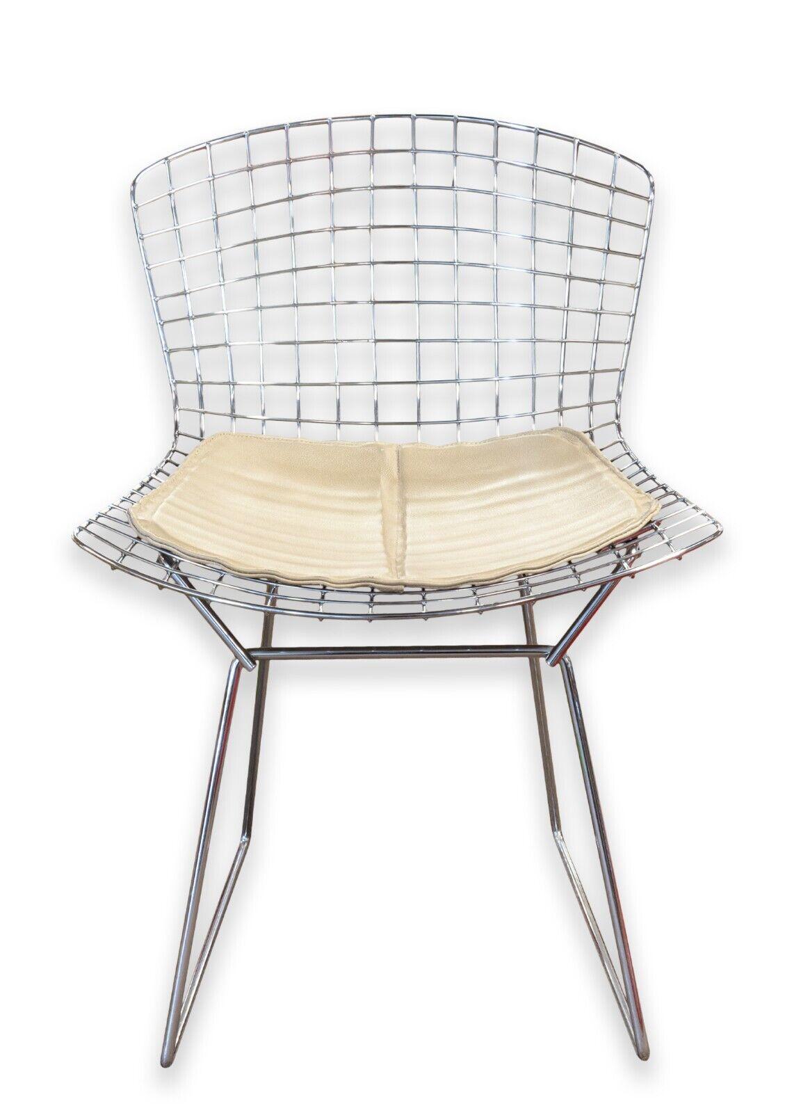 A set of 6 Harry Bertoia for Knoll wire side chairs. A wonderful set of clean, chic Bertoia wire side chairs featuring lovely beige leather seat pads, chrome wire construction, and a timeless mid century design. These 6 chair are in very good