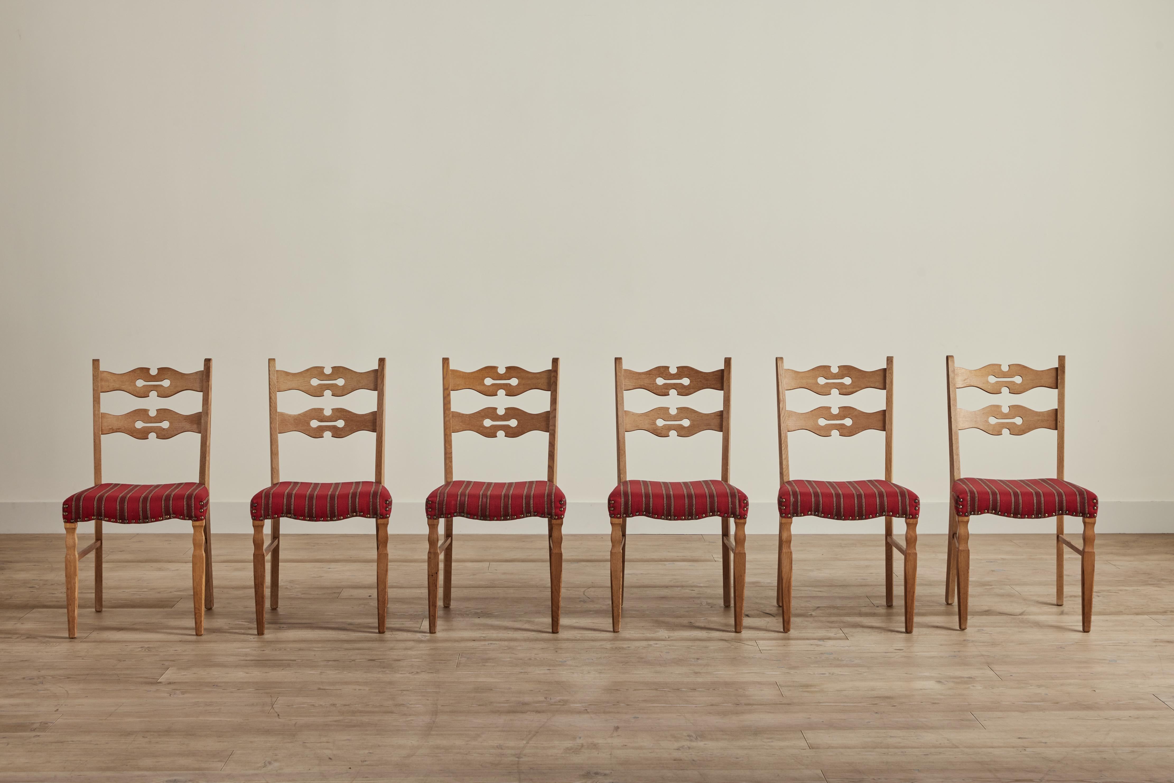 Set of six 1960s dining chairs attributed to Danish designer Henning Kjaernulf. These oak chairs are in very good condition and have their original wool fabric upholstery.