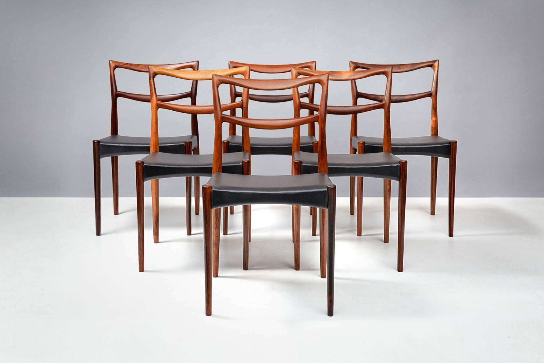 Henry W. Klein

Rosewood dining chairs, circa 1960.

Set of eight sculptural dining chairs produced by Bramin, Denmark, circa 1960 in stunning, exotic rosewood. The seats have been reupholstered in premium aniline black leather.

Larger sets