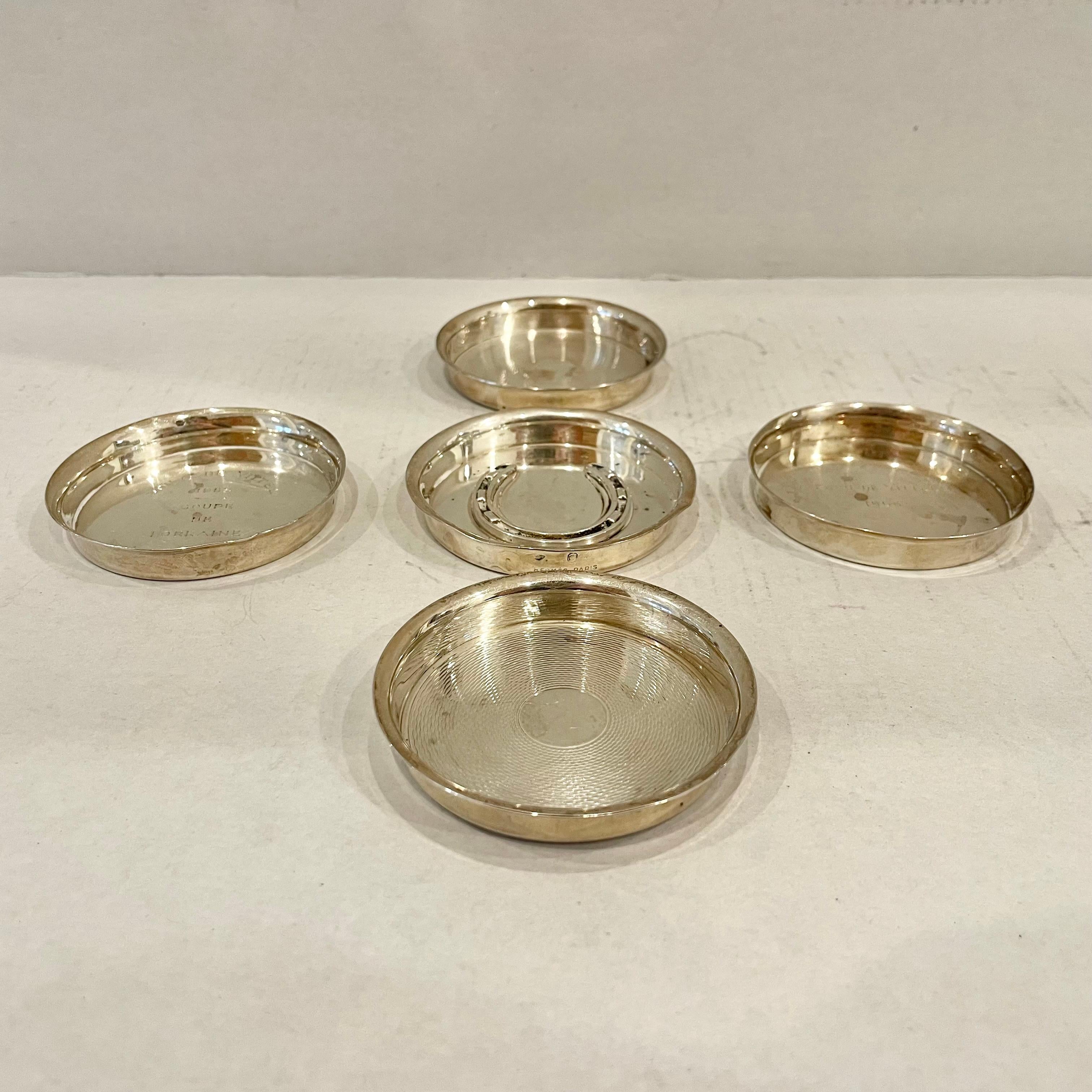 Beautiful set of Hermès jewelry dishes. Hermès stamped on the side or base of each piece. Silver plated hallmarks throughout. Different designs on almost every dish. 2 of the five dishes have a scale design, one has an equestrian design while the