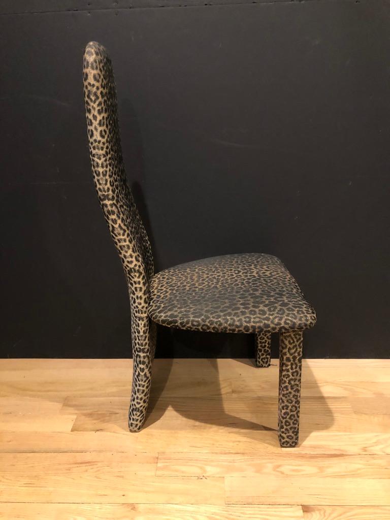 Set of six (6) leopard print high back contemporary dining chairs. A single plank forms both the backrest and acts as the back legs.