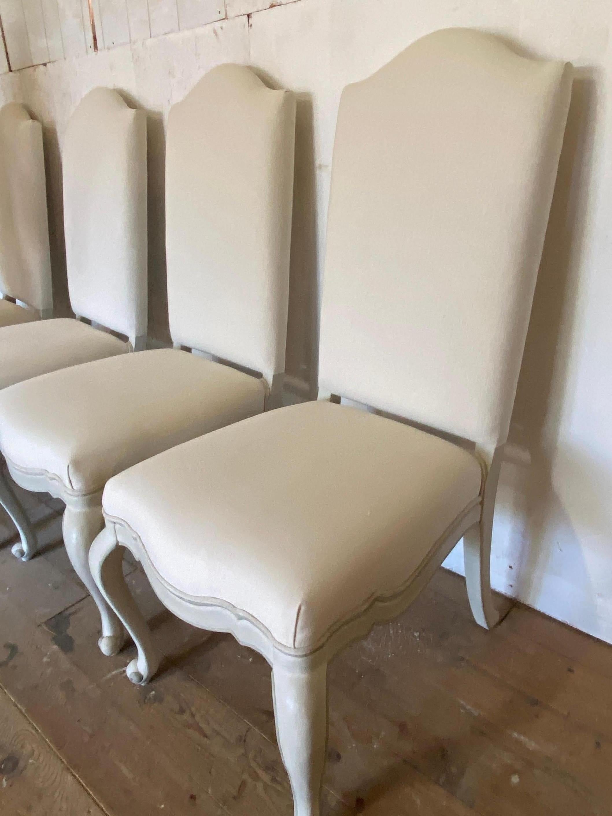 Set of 6 high back Louis XV, French Provincial size painted dining chairs upholstered with white linen fabric, painted a light grey with darker grey trim. Front two legs of each chair have carved details.