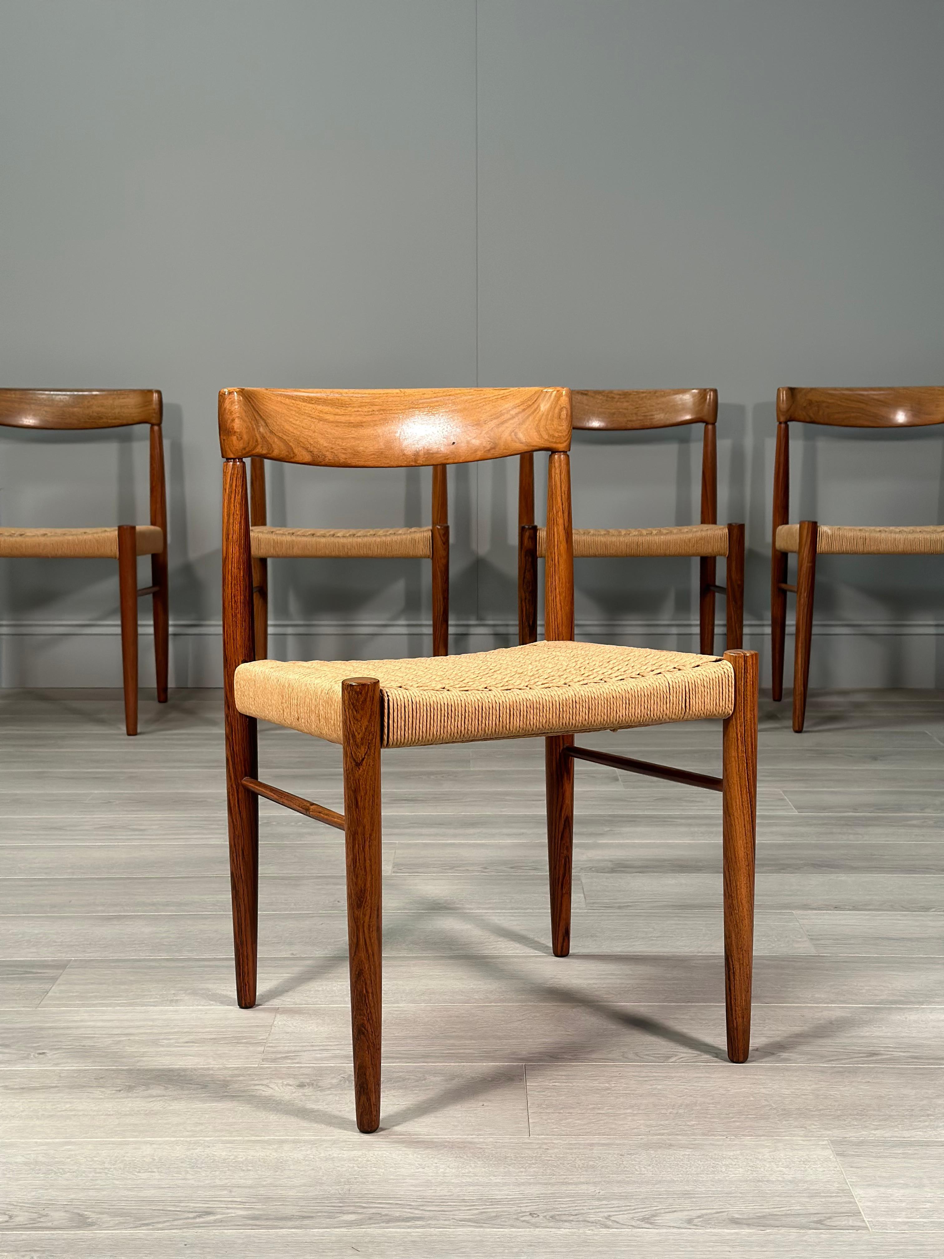 A superb set of 6 dining chairs designed by H.W. Klein for Bramin, Denmark. The Chairs have a solid rosewood frame with original paper cord seats all of which are in very good condition with some slight discolouration to one.