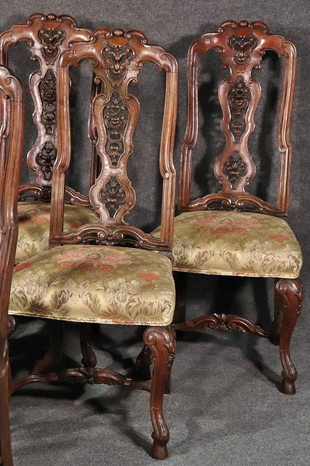 This is a gorgeous set of 6 Italian antique 1890s era carved walnut dining side chairs. The upholstery is a second re-upholstery and is in need of updating. These are beautiful chairs and would look wonderful with a newer silk upholstery.