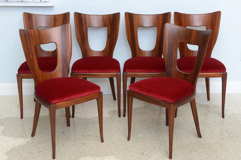 The rounded backs with pierced area on tapering splayed legs, each with label to inside of seat frame, Borsani atelier.
