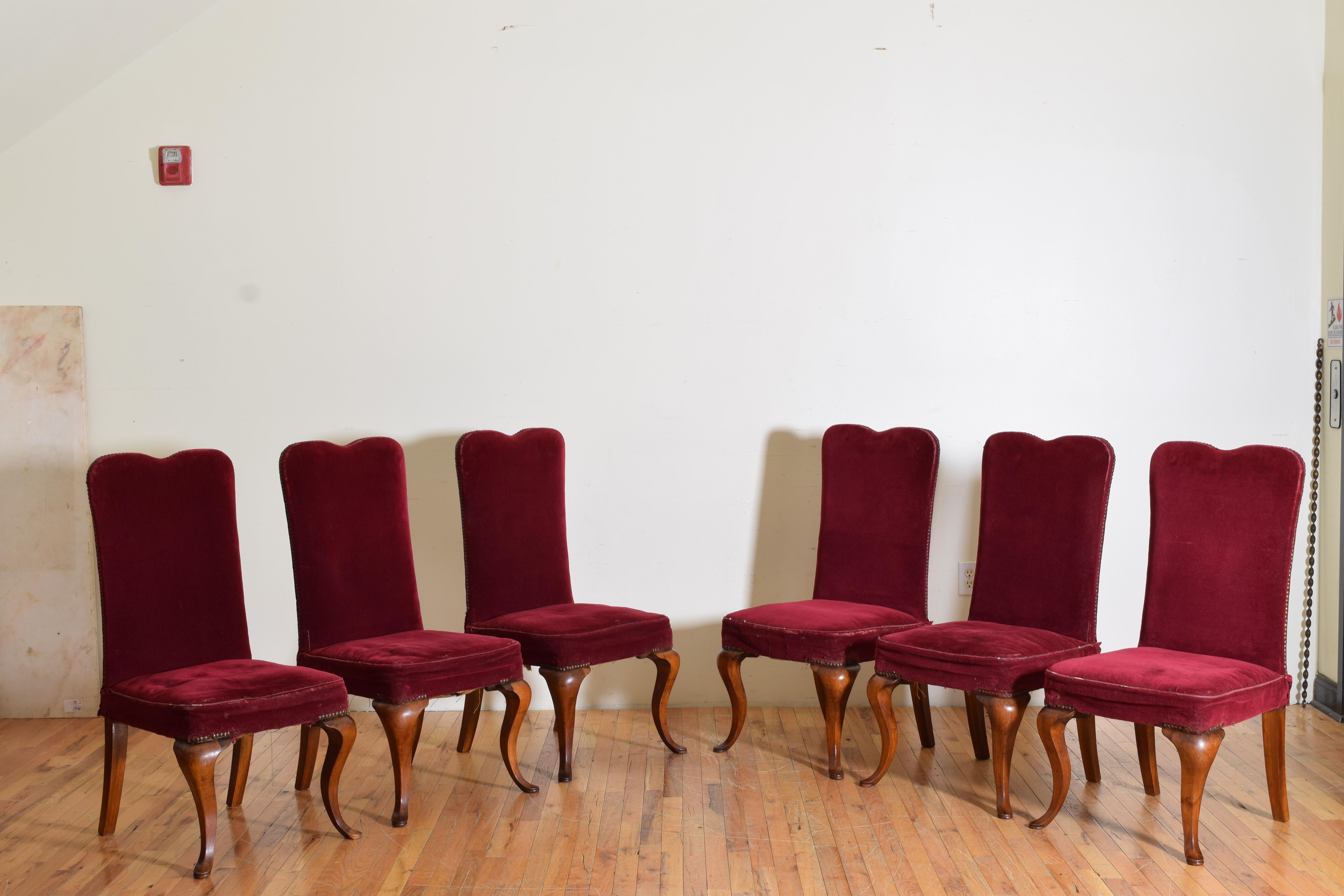 Upholstered in vintage red velvet these dining chairs have mustache shaped backrest and generous fitted seats, raised on splayed rear legs and elegantly shaped front legs ending in pad feet, constructed of beautifully grained walnut.
