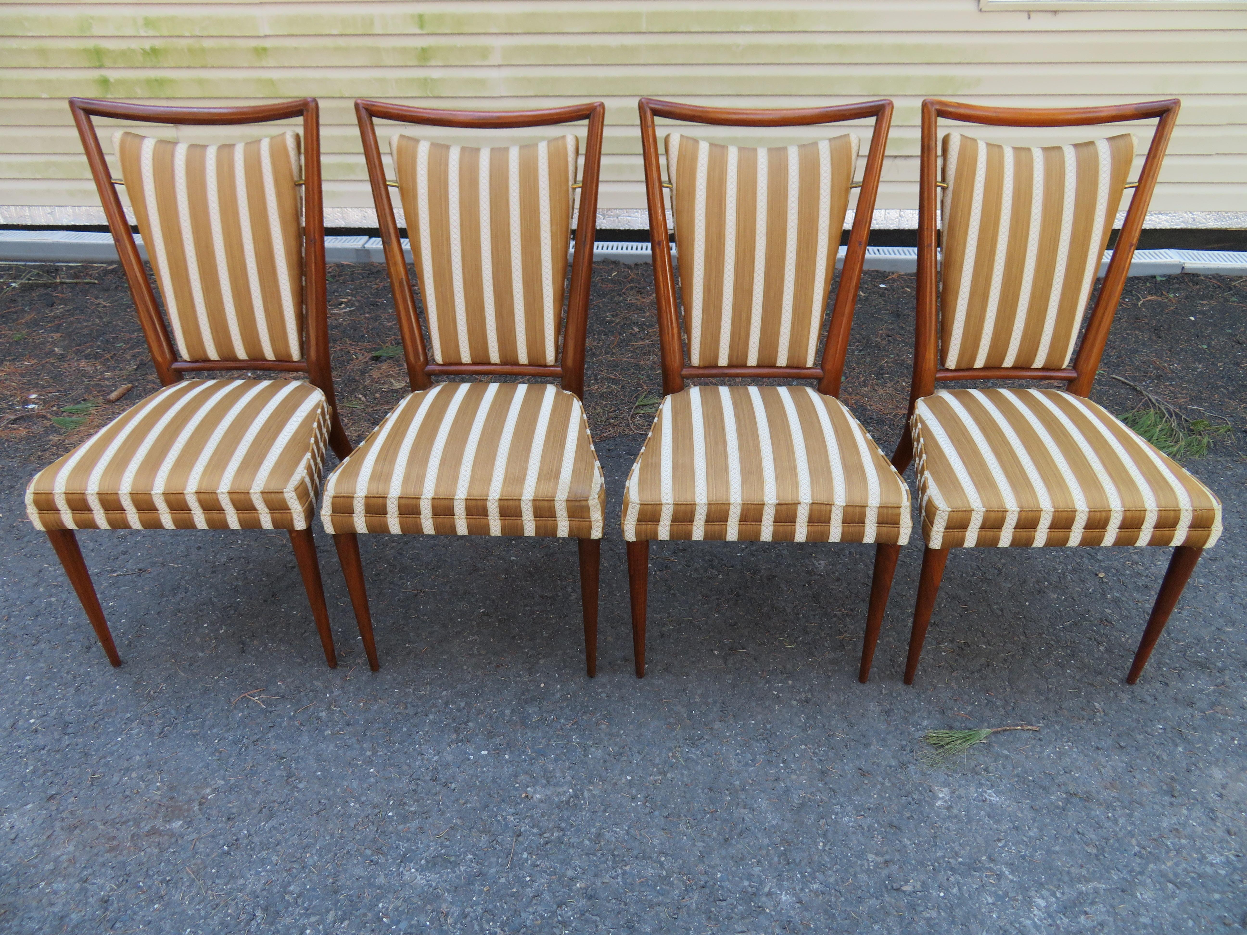 Set of six late 1950s Widdicomb modernist dining chairs in walnut with upholstered seat and floating back cushions held suspended by brass fittings. Designed by J. Stuart Clingman. The sinewy lines, tapered legs and floating back panel are similar