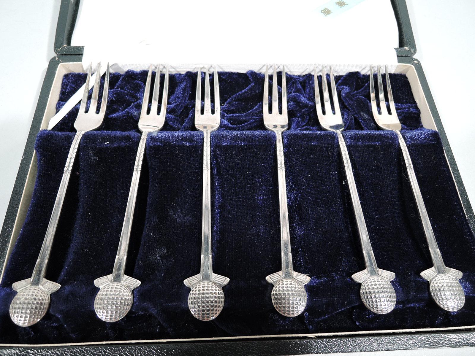 Set of 6 Japanese modern silver appetizer forks with golf motif. Handle in form of two upside down clubs with heads supporting ball. Narrow shank with 3 tines. In leather-bound case with silk lining and fitted velvet. A great gift for the swinger in