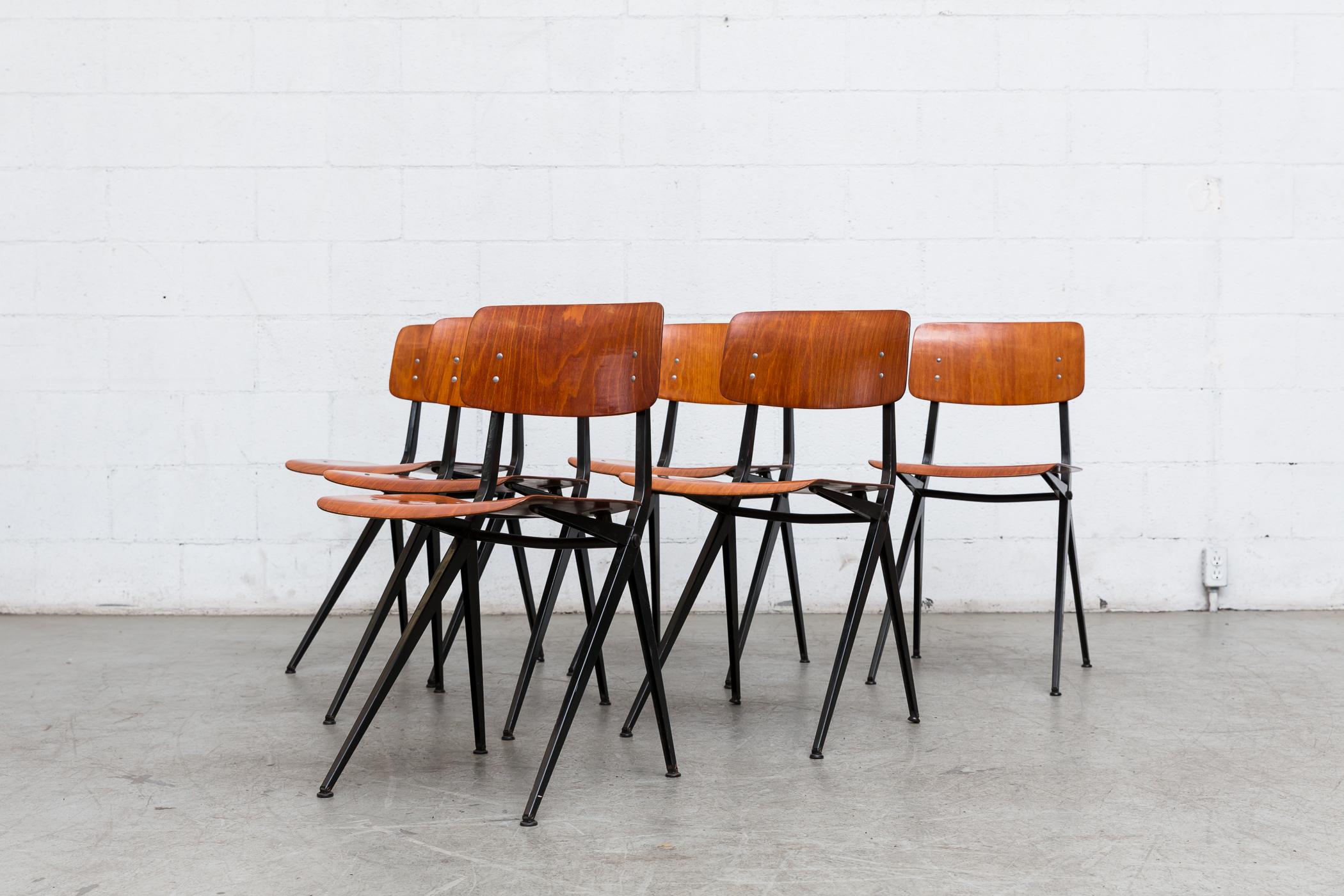 Rare Mid-Century resined teak non-stacking school chairs with Prouve style Compass Legs. These chairs have rich teak toned plywood seats and backs with folded black enameled sheet metal frames. These are in VERY Original Condiiton and Have Visible