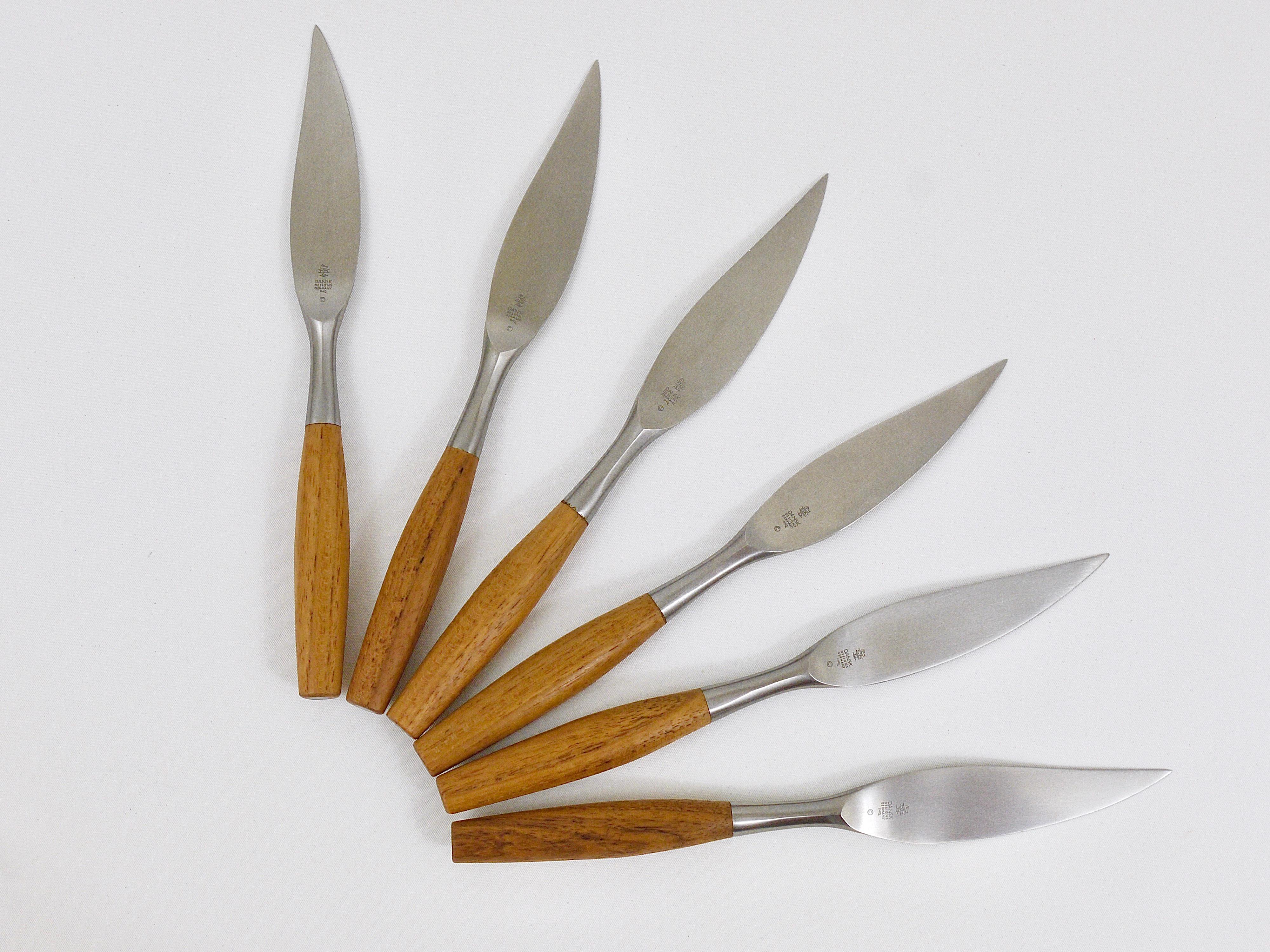 A set of six midcentury Danish modern steak knives, designed in the 1950s by Jens Quistgaard for Dansk. Beautiful and hard-to-find cutlery made of stainless steel with beautiful teak handles, which is part of the collection of the Museum of Modern