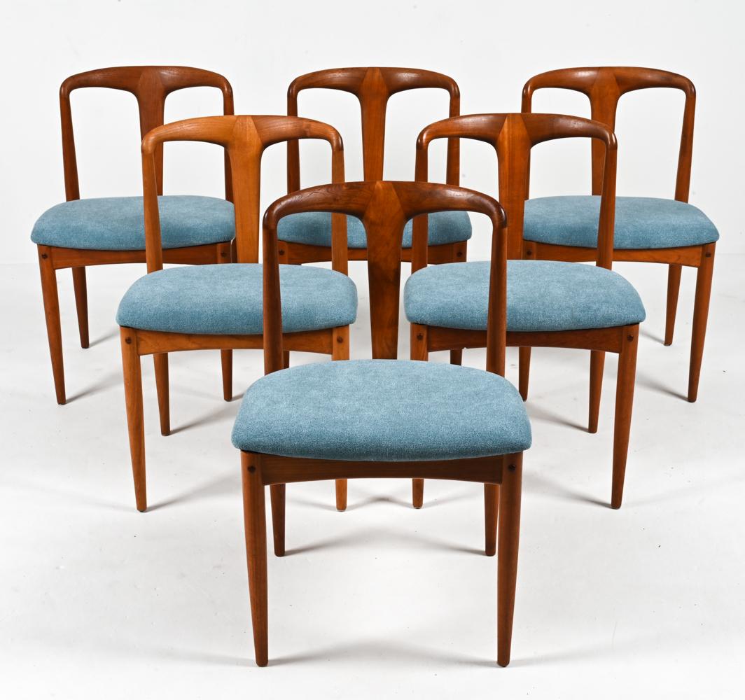Elevate your dining experience with this exquisite set of six iconic Juliane chairs by Johannes Andersen for Uldum Møbelfabrik, crafted in lustrous teak wood and featuring striking blue-green woven fabric. These chairs are a harmonious blend of
