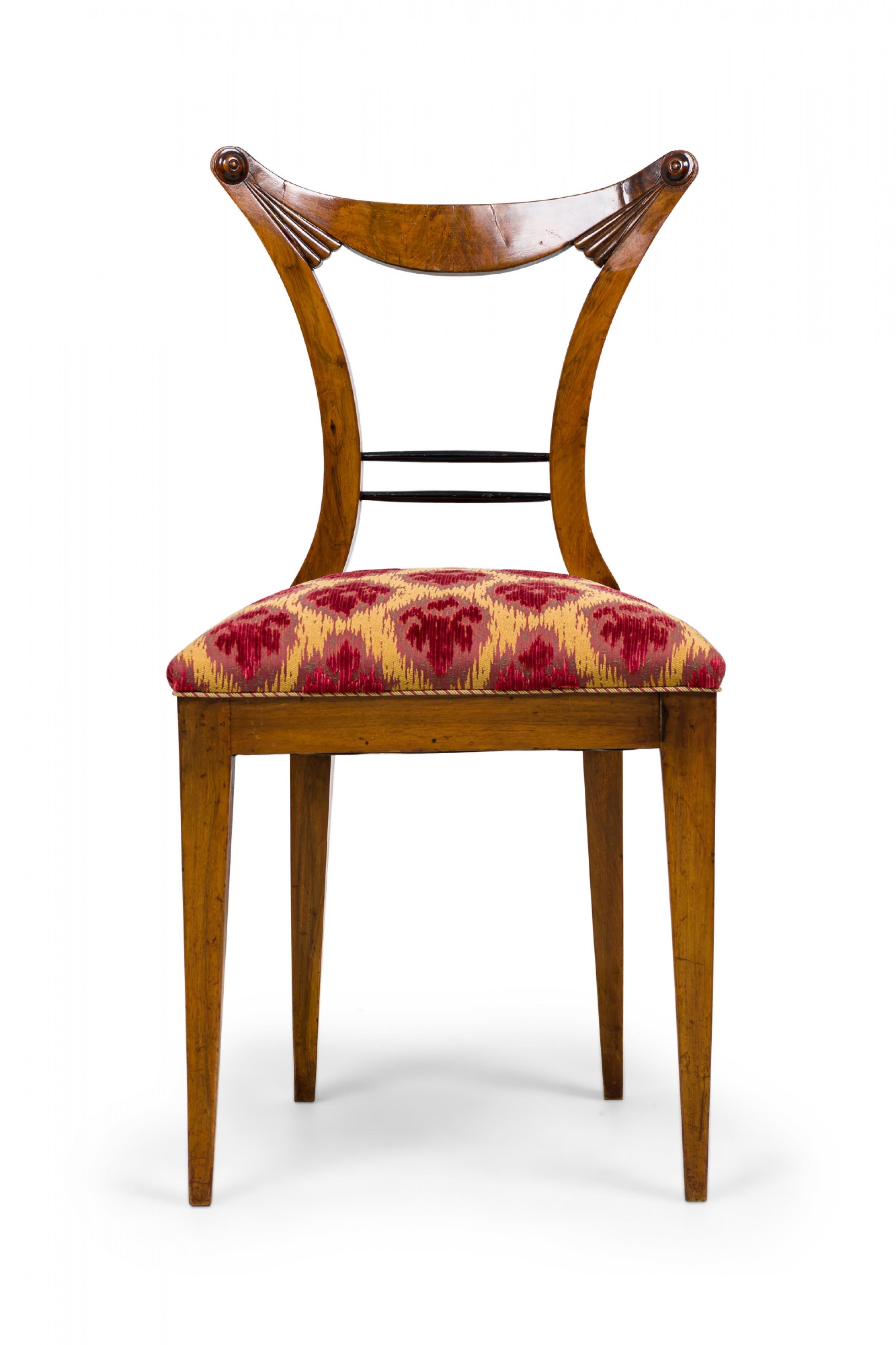 SET of 6 Biedermeier Viennese (19th Century) dining chairs with a concave styled openwork backrest & carved embellishments, 2 turned horizontal supports, the seat cushion upholstered in an abstract red & yellow patterned fabric bordered by striped