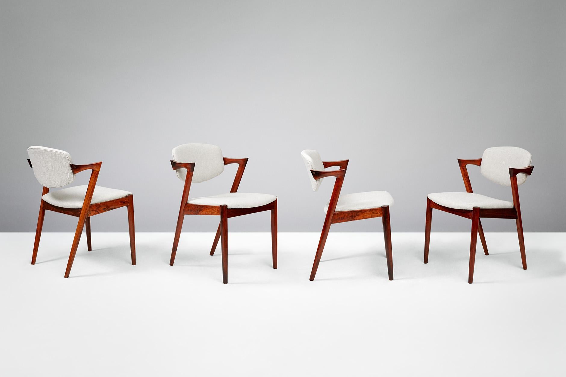 Kai Kristiansen

Model 42 dining chairs, 1956.

Set of 6 dining chairs produced by Skovman Andersen for the Illum Bolighus department store in Copenhagen. Refinished rosewood frames with seat and back reupholstered with Kvadrat Hallingdal wool
