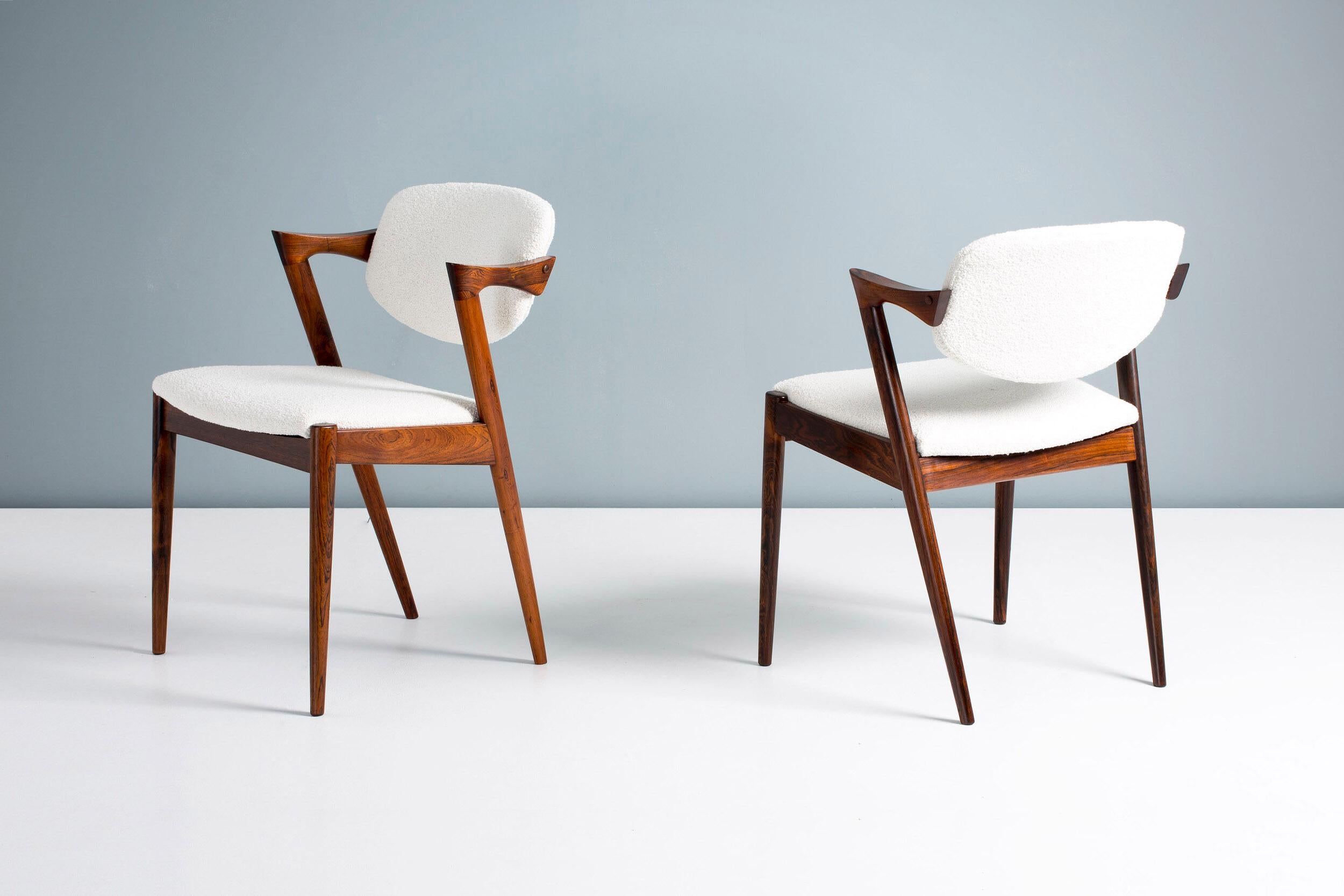 Kai Kristiansen

Model 42 dining chairs, 1956.

Set of 6 dining chairs produced by Skovman Andersen for the Illum Bolighus department store in Copenhagen. Refinished rosewood frames with seat and back reupholstered with Chase Erwin embrace