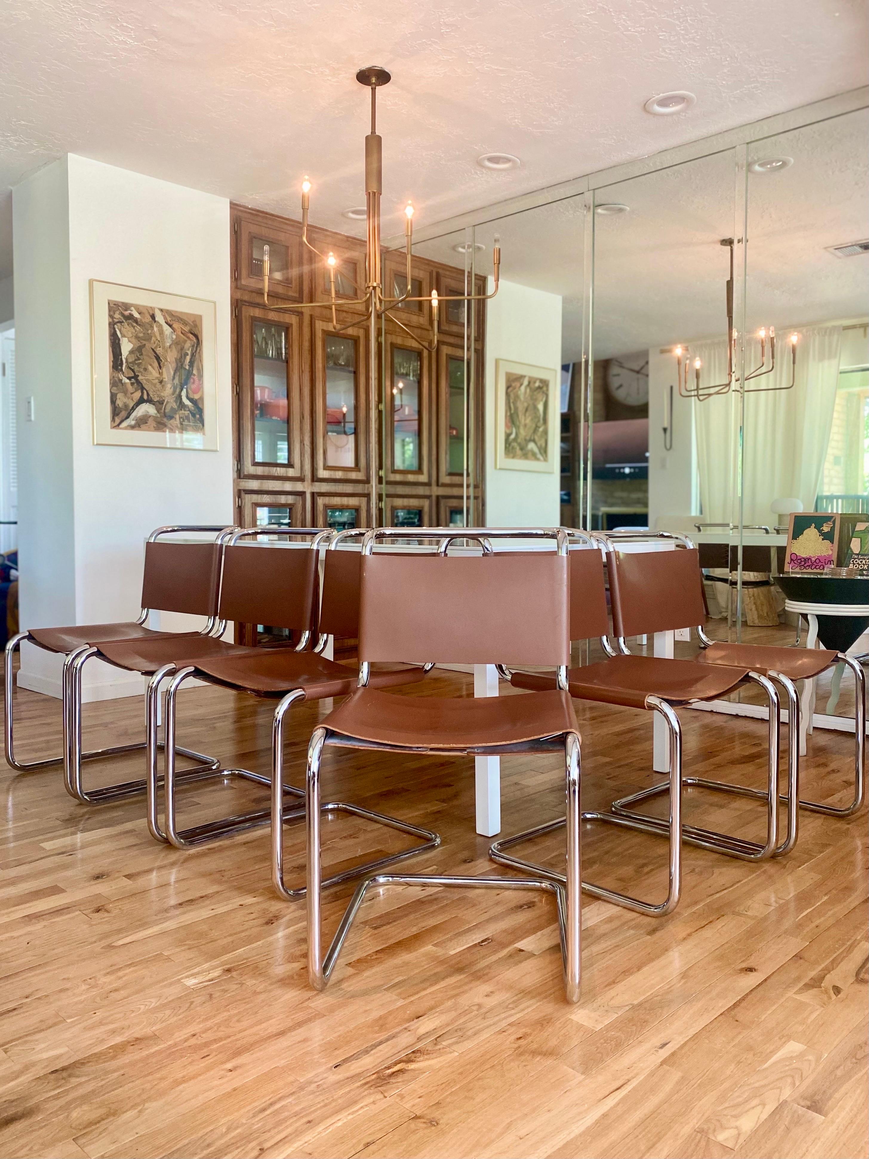 Set of six iconic Spoleto/B33 dining chairs designed by Marcel Breuer for Knoll, c.1970s. Cognac leather seats and backs wrap around the cantilevered chrome frames with corset ties. A piece of Bauhaus design history, this set is