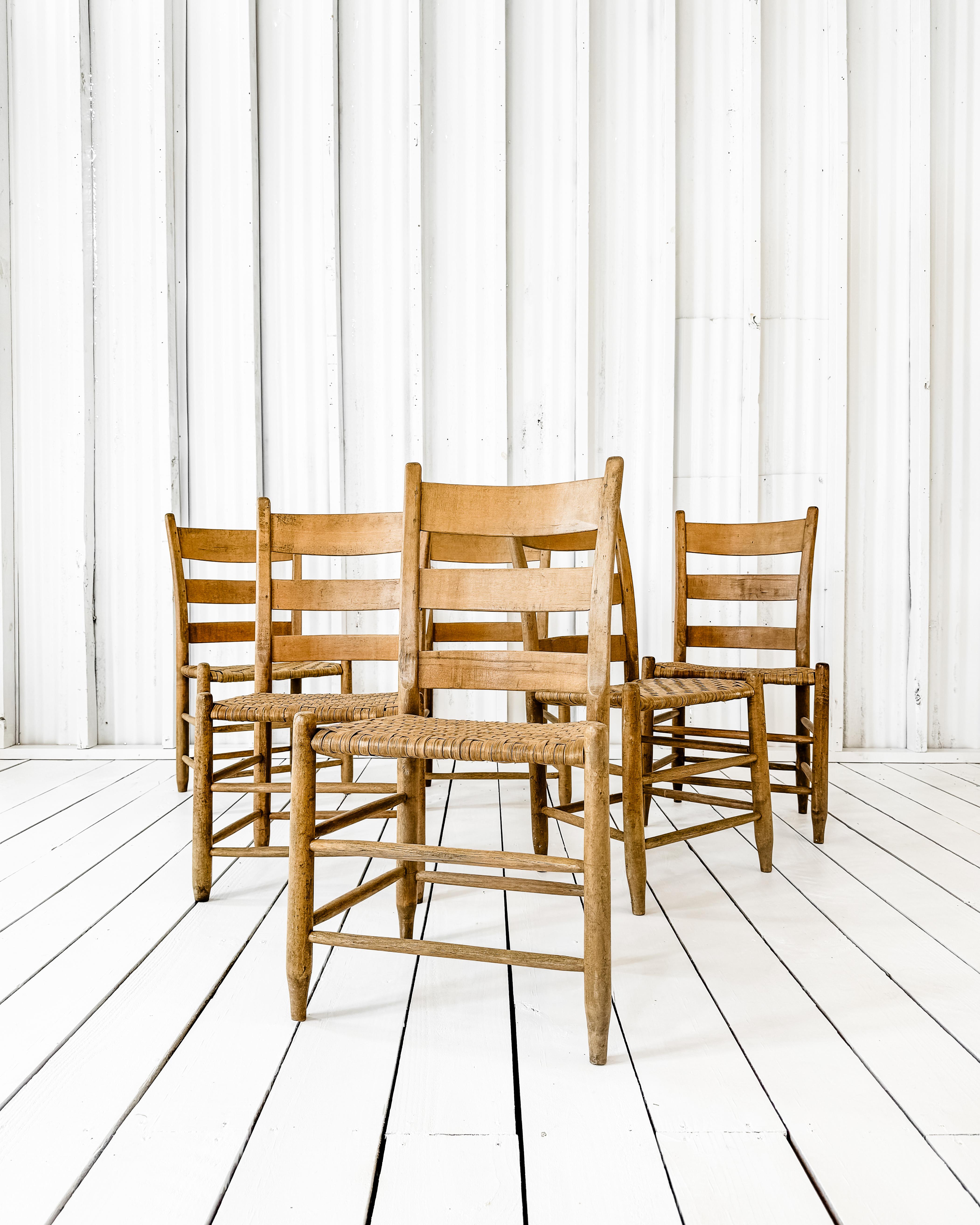 Antique set of 6 Richard Poynor splint weave chairs. Meticulously handcrafted using mortise and tenon joinery, the chairs feature beautiful herringbone woven seats. Sturdy and having a lovely honey-tone shade, these chairs will add a sense of