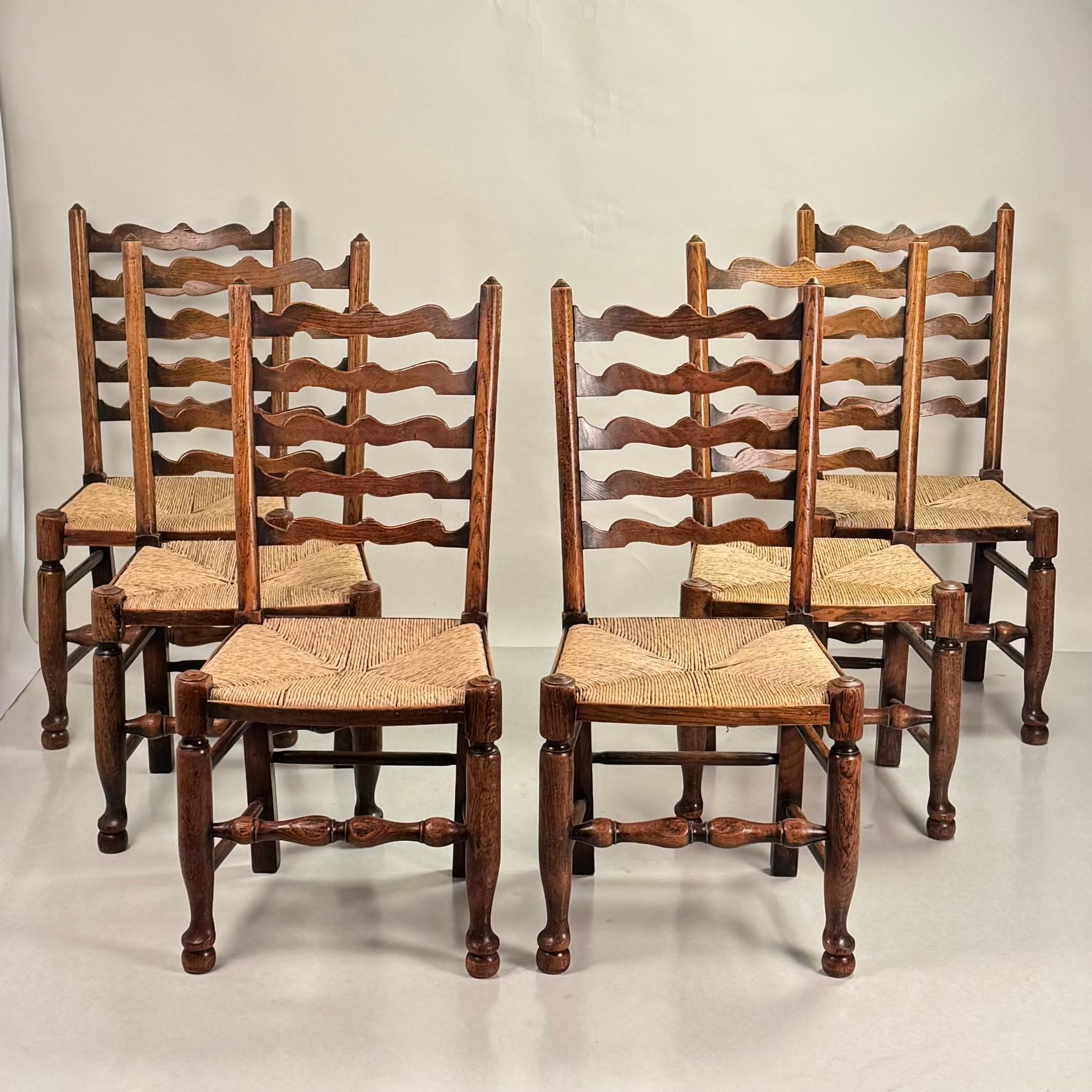 Set of 6 large English ladder back oak and rush dining chairs.

Sold as a set only.