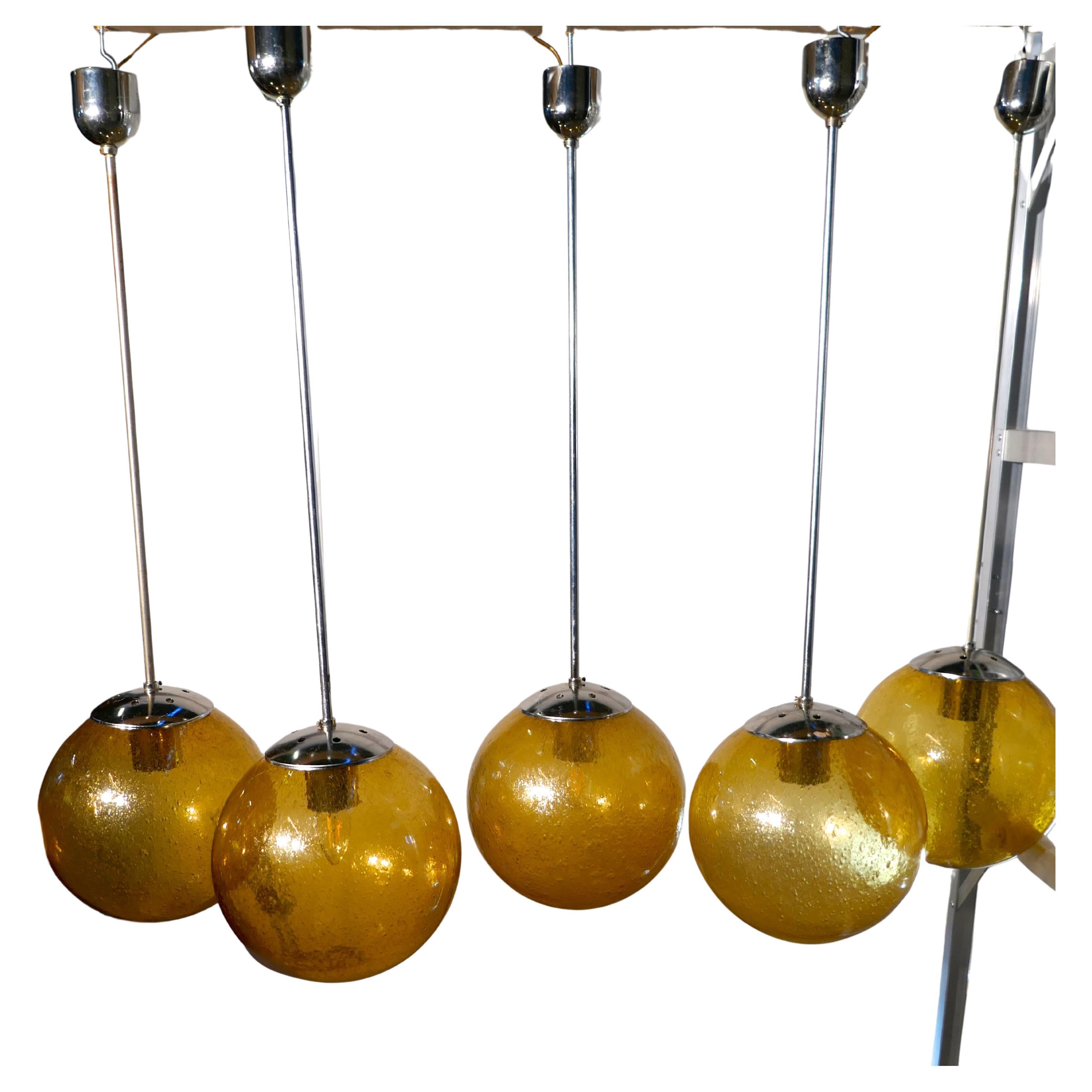 Set of 6 Large Retro Amber Globe and Chrome Lights

I rare find, these lights have been used but they are in close to original condition, the original Amber Glass Raindrop Globe Shades even have their original cardboard cartons
The globes are