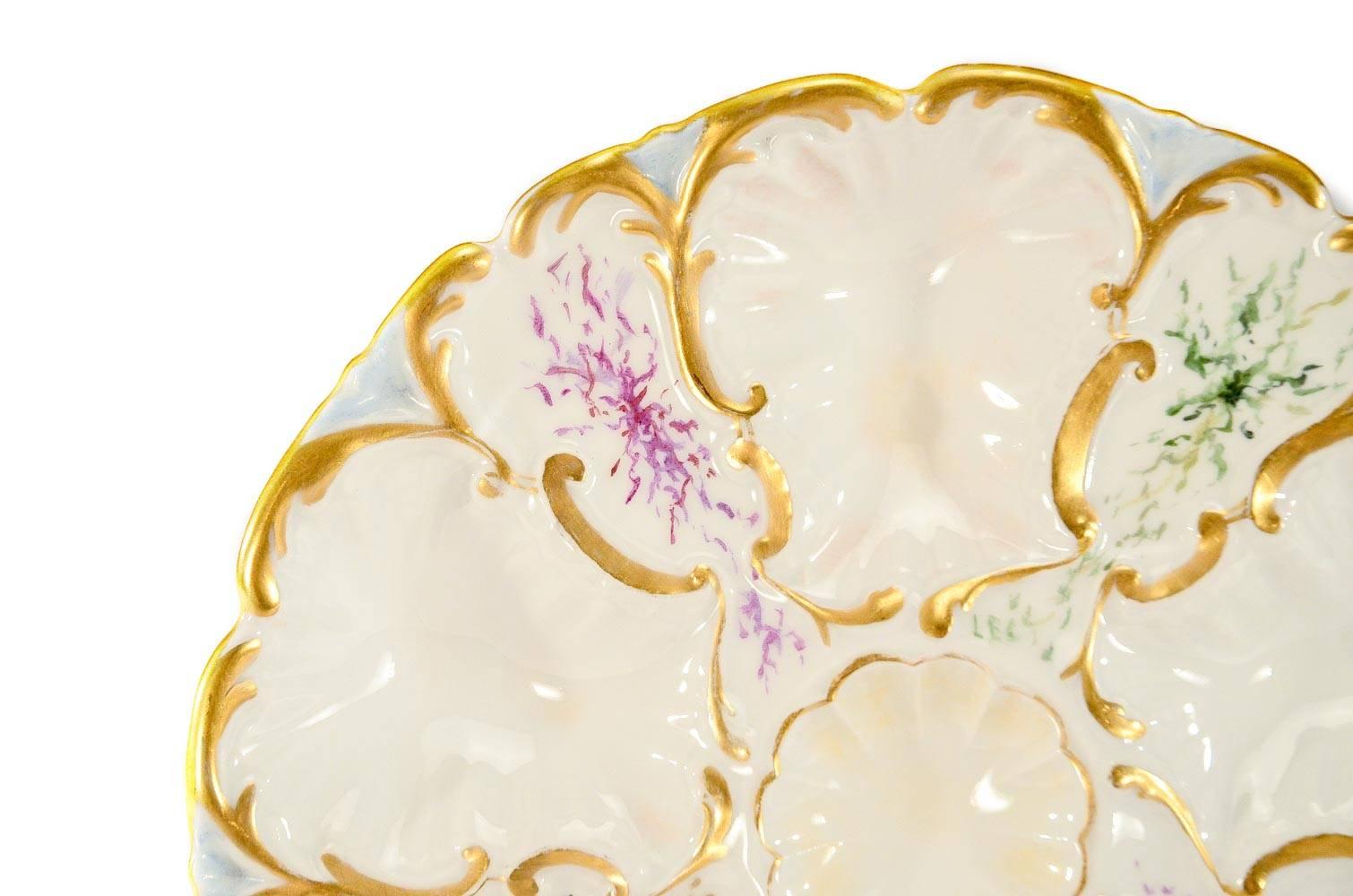 Perfect for serving oysters or other h'ors d'oeuvres and a wonderful addition for the oyster plate collector, this set of 6 plates is sure to be appreciated. The blank has molded relief and each reserve is decorated with a hand painted seaweed motif