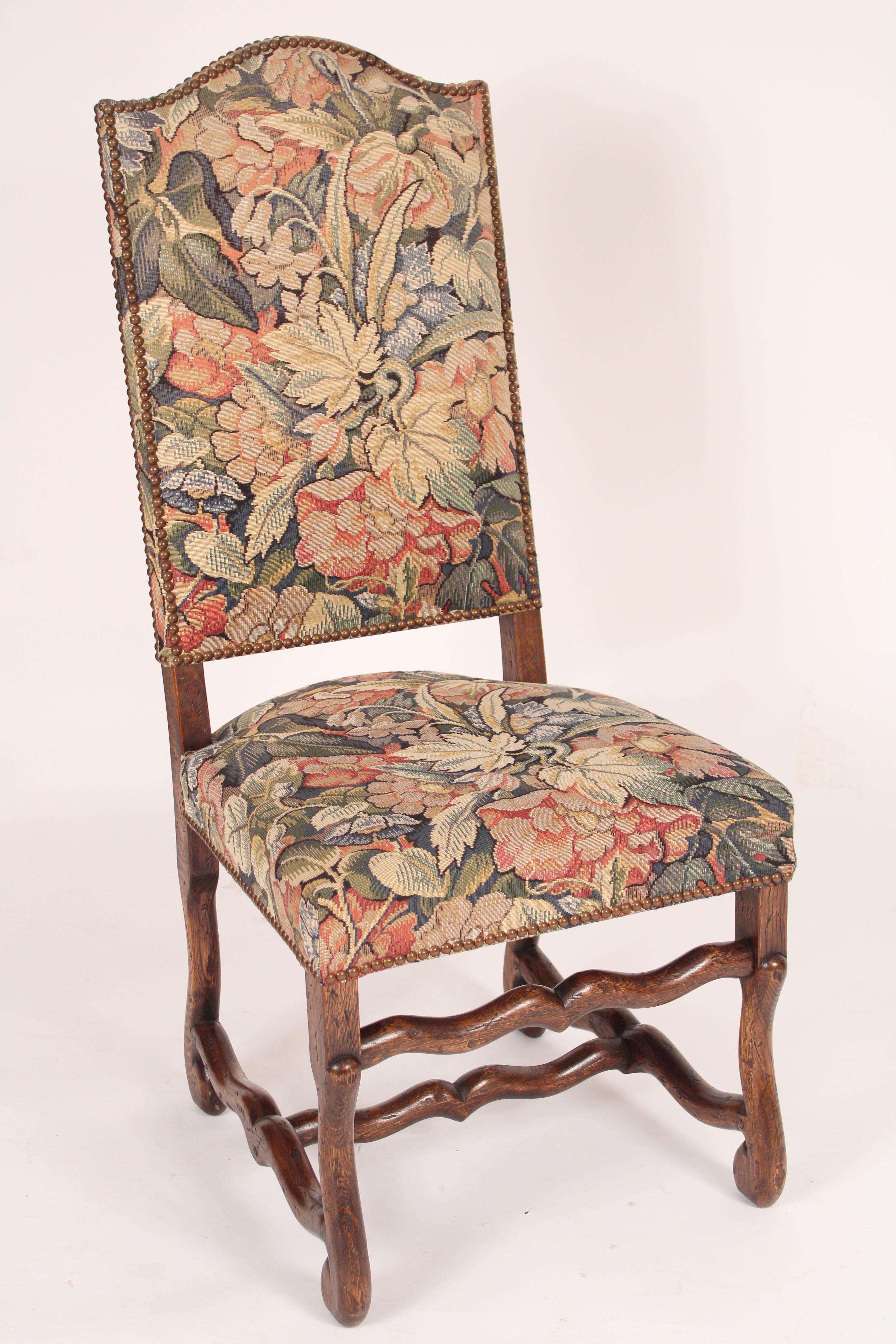 Set of 6 Louis XIV style oak dining room chairs upholstered in a tapestry style upholstery, circa late 20th century. The set consists of 2 arm and 4 side chairs. The oak has nice color, looks like it's 19th century or earlier. With dowel