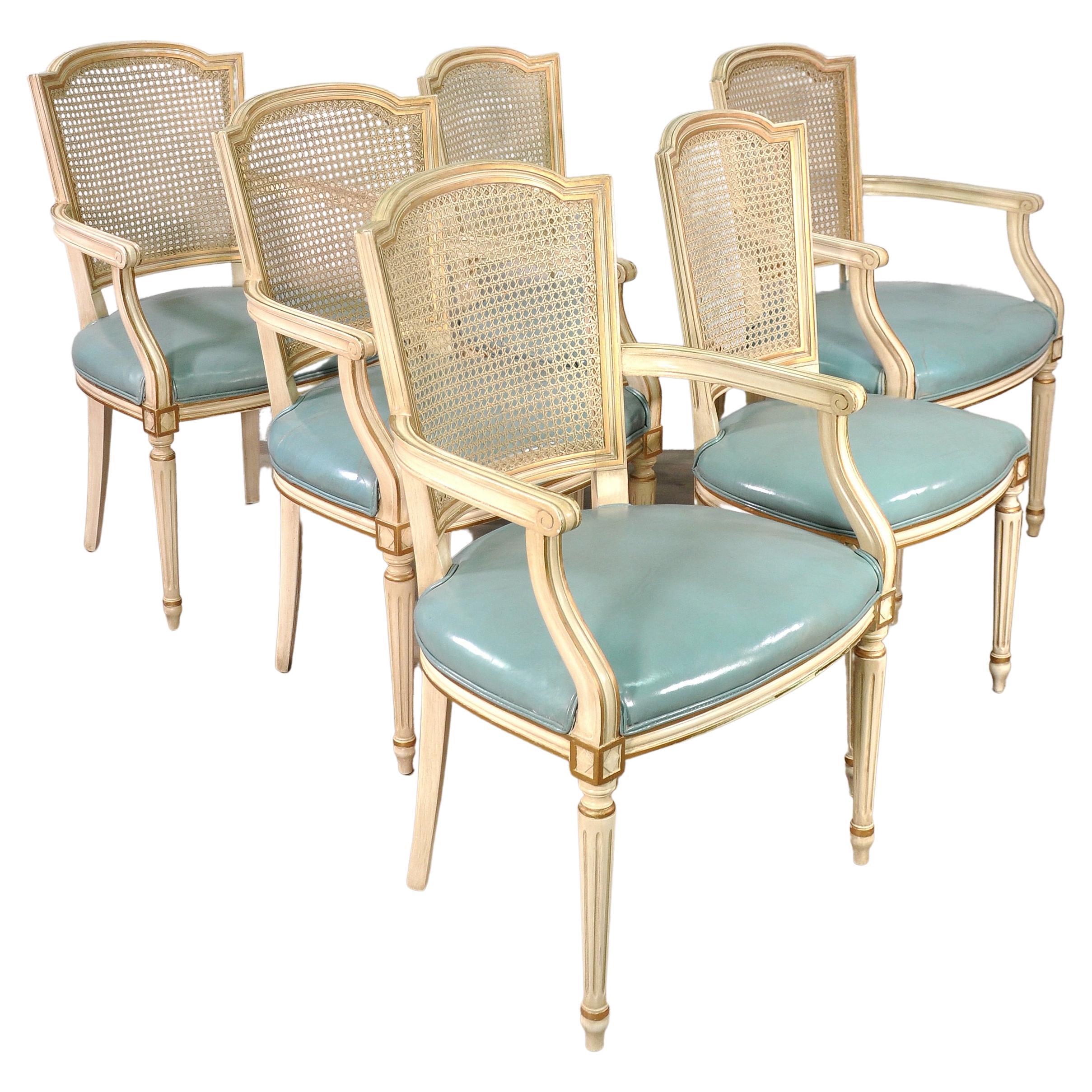 Set of 6 French Louis XVI Style Painted and Gilt Dining Chairs with Rattan Backs, the perfect choice for timeless Neoclassical styling with fine dining comfort! The shield shaped seatbacks are caned for light weight and ideal for warm climates. The