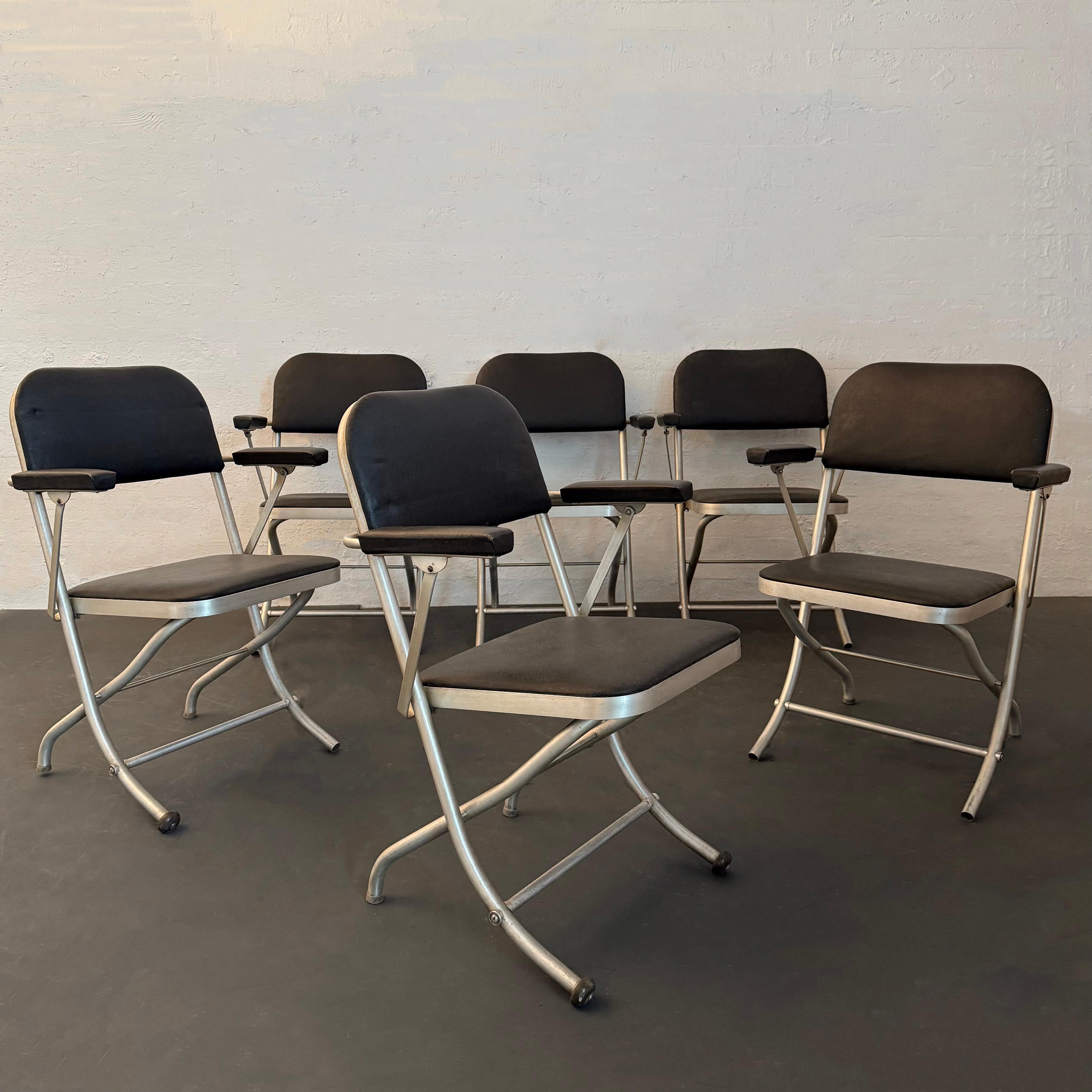 This set of six Art Deco / Machine Age folding chairs were designed by American designer Warren McArthur circa 1930s manufactured by Mayfair Industries. Each chair features its signature tubular aluminum frame with it’s original black vinyl