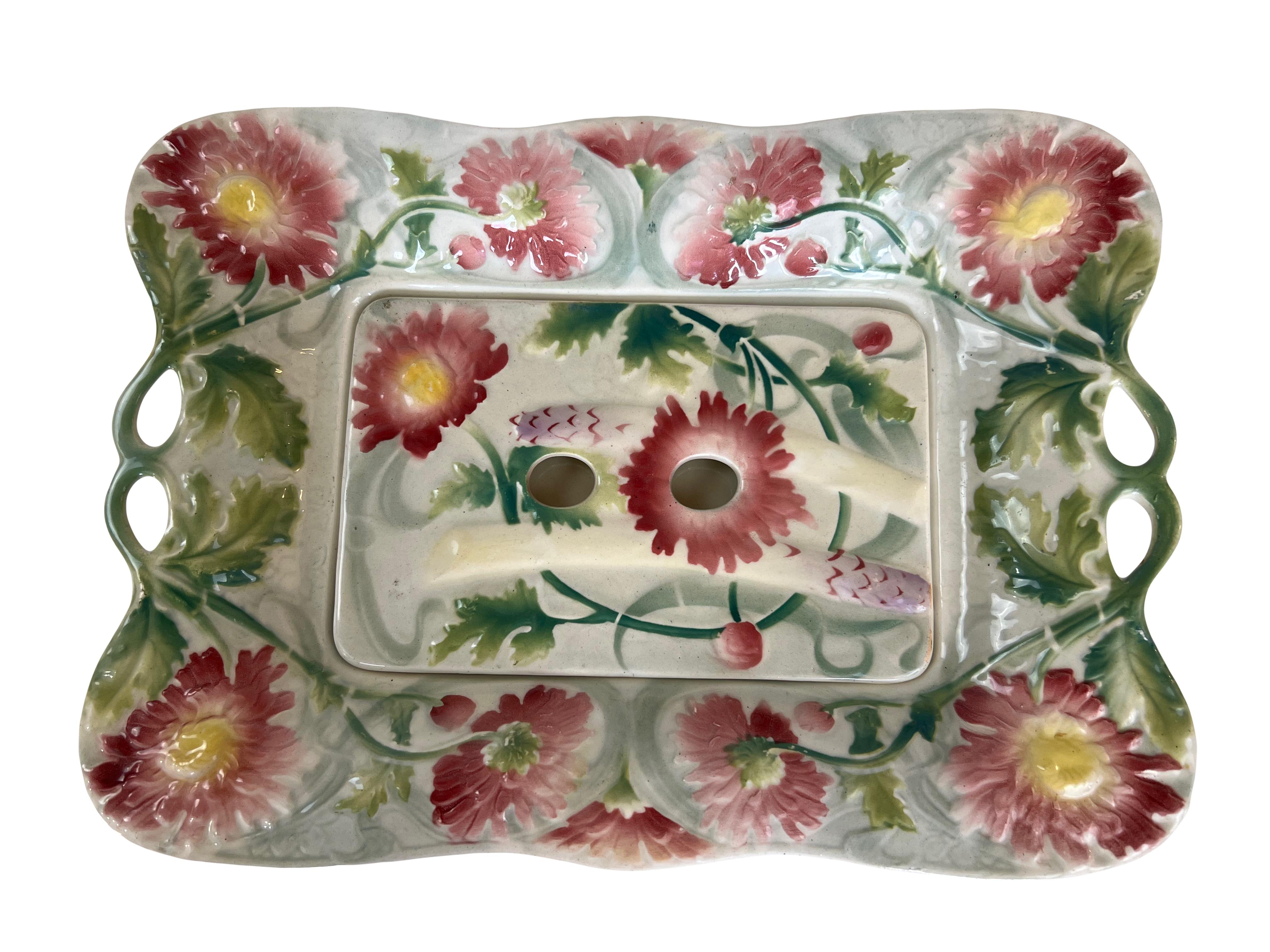 This exquisite faience set from the renowned Saint Clément manufactory includes 6 majolica asparagus plates and an asparagus serving platter with a built-in strainer. The set embodies the Art Nouveau style, featuring vibrant and detailed