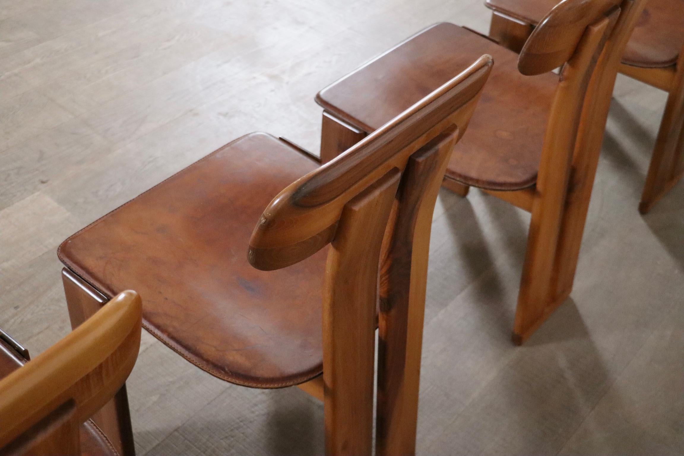 Amazing set of six Sapporo dining chairs designed by Mario Marenco for Mobil Girgi in Italy in 1970. Made from Italian walnut with a stunning grain pattern and beautiful patinated cognac saddle leather seats. The seats are original and have aged