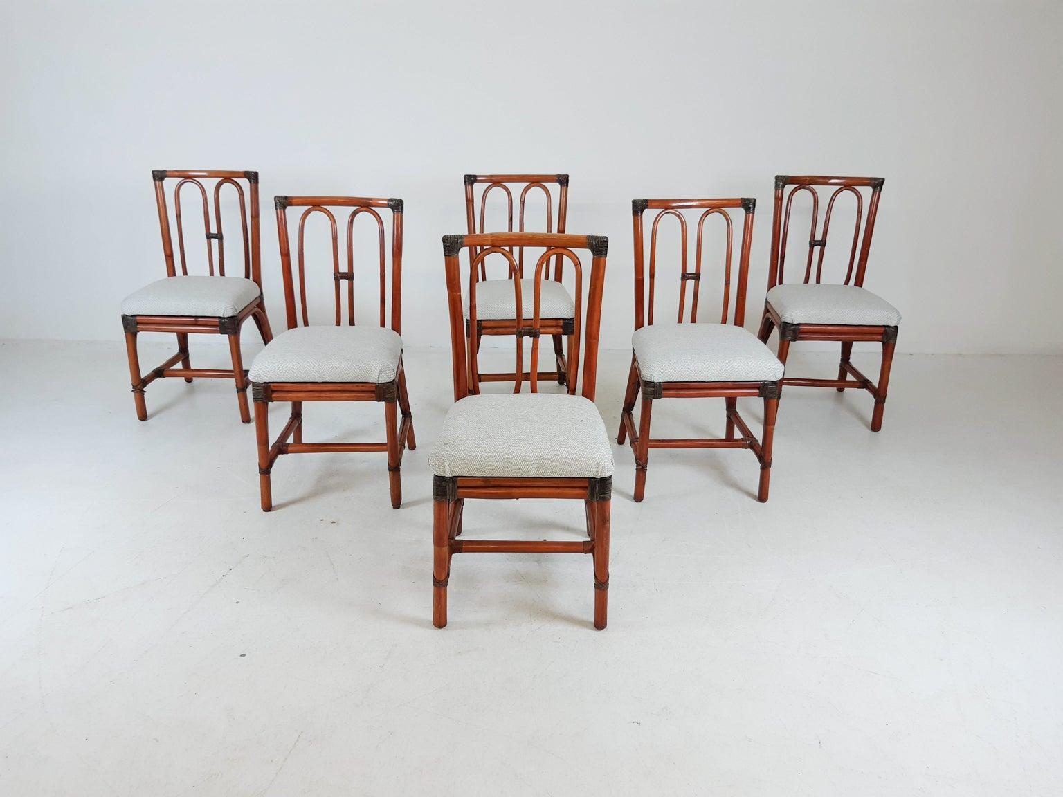 Set of six bamboo dining chairs with leather straps and new fabric. We think they were made by McGuire.

In good condition. A few leather straps have come loose. This is only aesthetic and does not affect firmness.