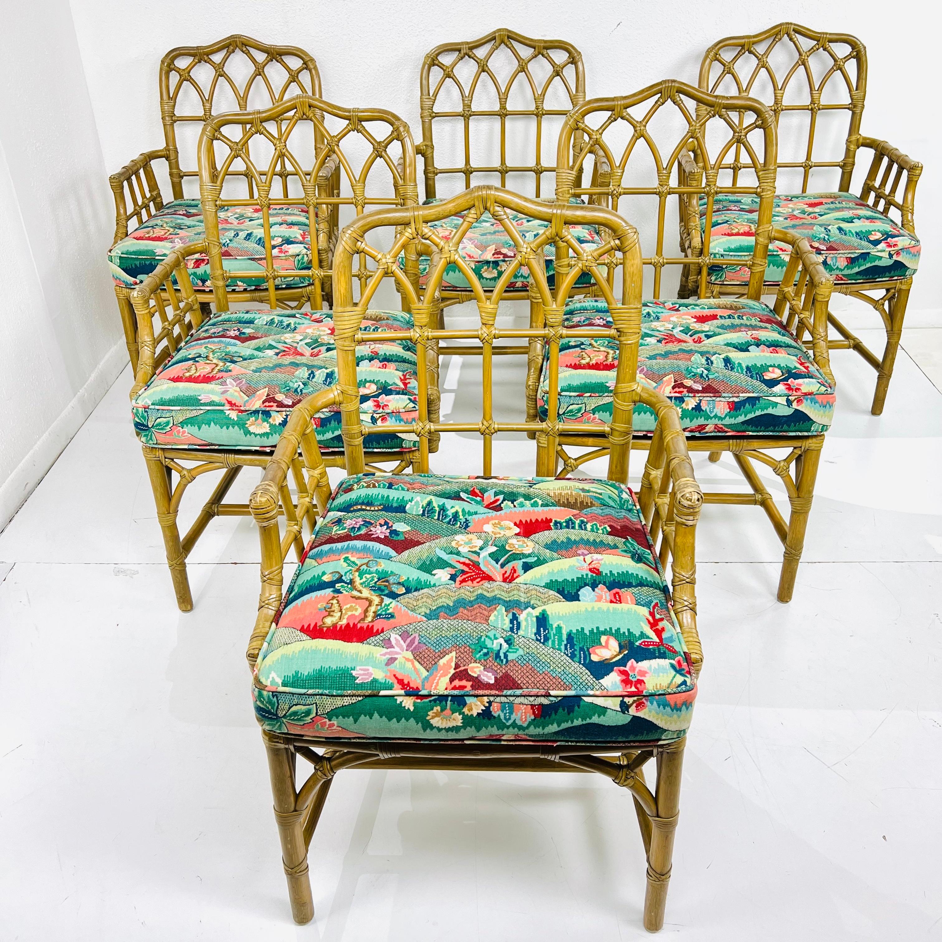 Fantastic set of 6 McGuire rattan dining chairs in the original finish, with rawhide laces and recently upholstered cushions. The set includes six armchairs and each chair has the McGuire plate and iconic pearl M. Beautiful patina for the perfect