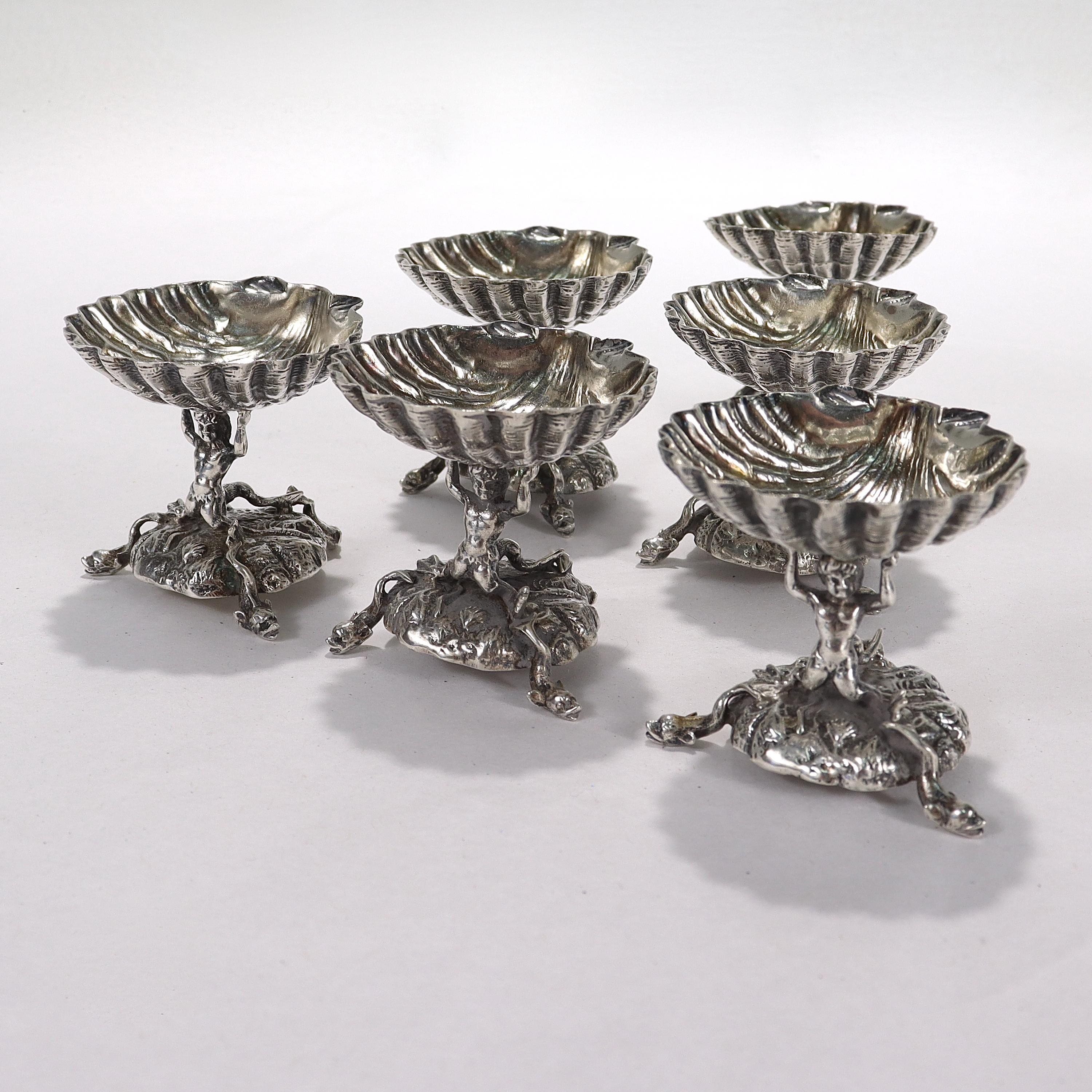 A fine set of 6 salt cellars.

By Fratelli Coppini.

In .800 Italian silver.

In the form of a seashell held atop the shoulders of a mermaid/merman. The base is supported by 3 figural dolphin feet.

Simply a lovely set of nautical themed salt